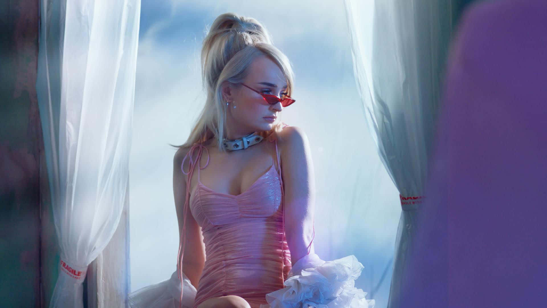 Caption: Kim Petras Gracefully Performs On Stage Wallpaper