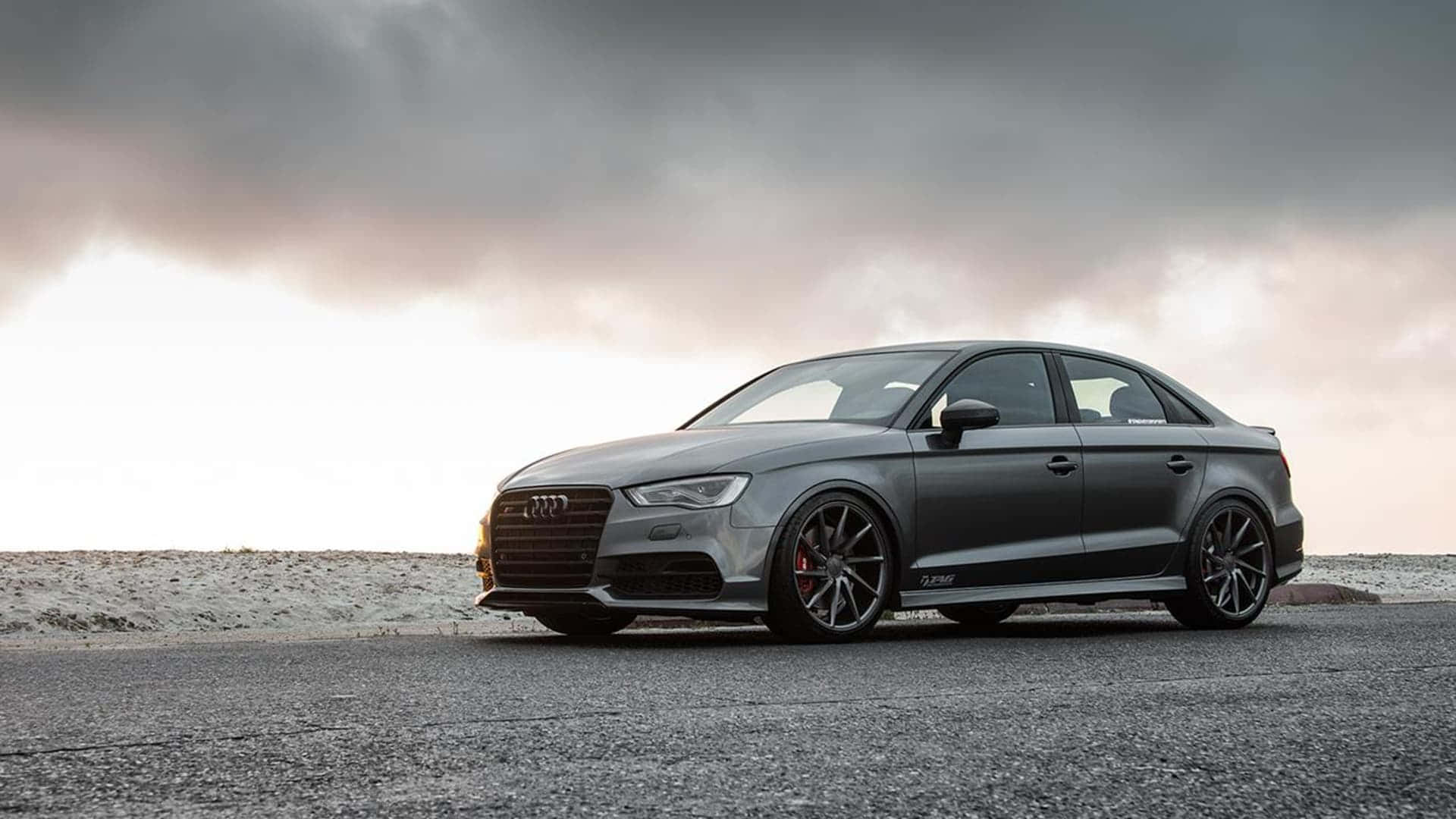 Caption: Luxurious Audi S3 Speeding On An Open Road Wallpaper