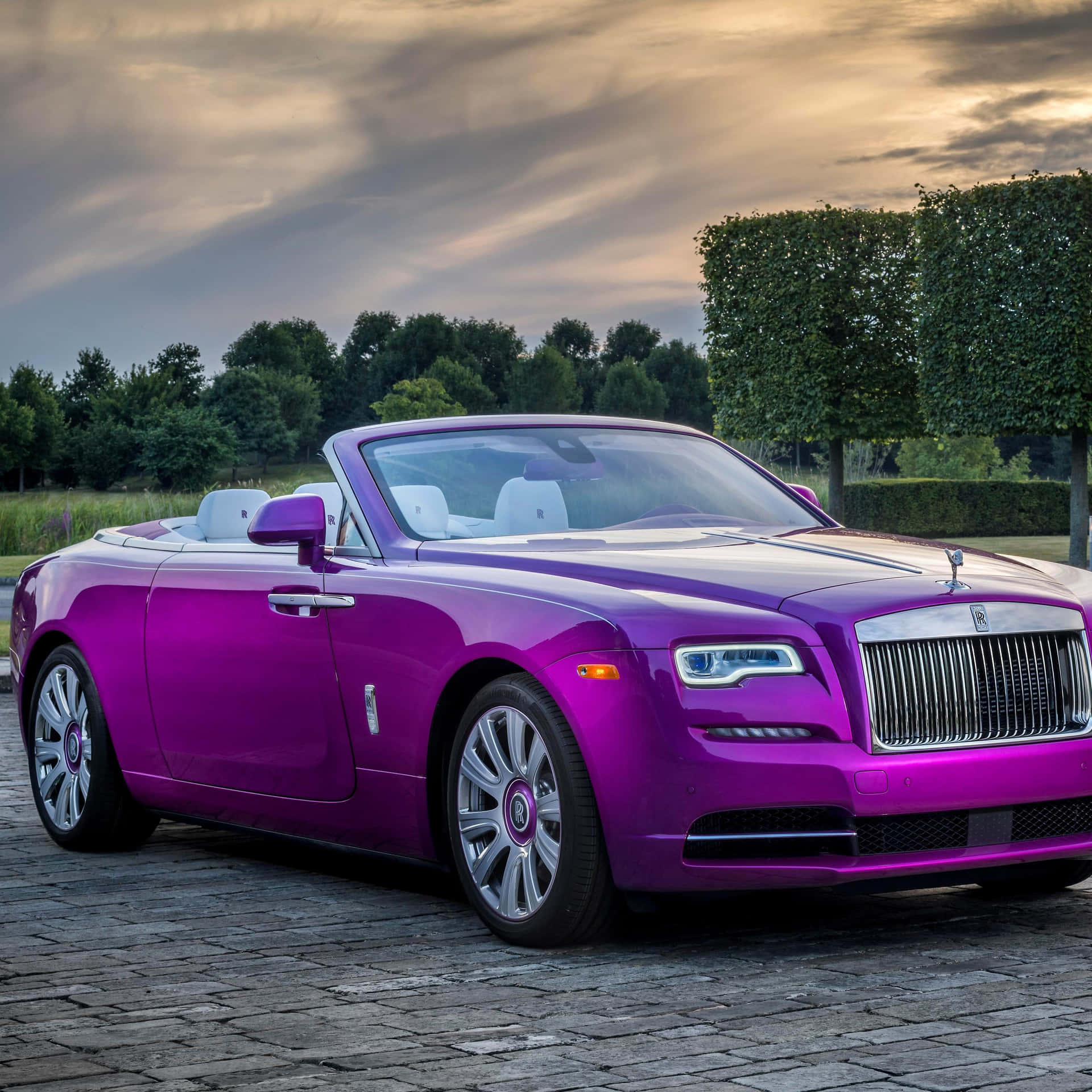 Caption: Luxurious Rolls Royce Dawn At Sunset Wallpaper