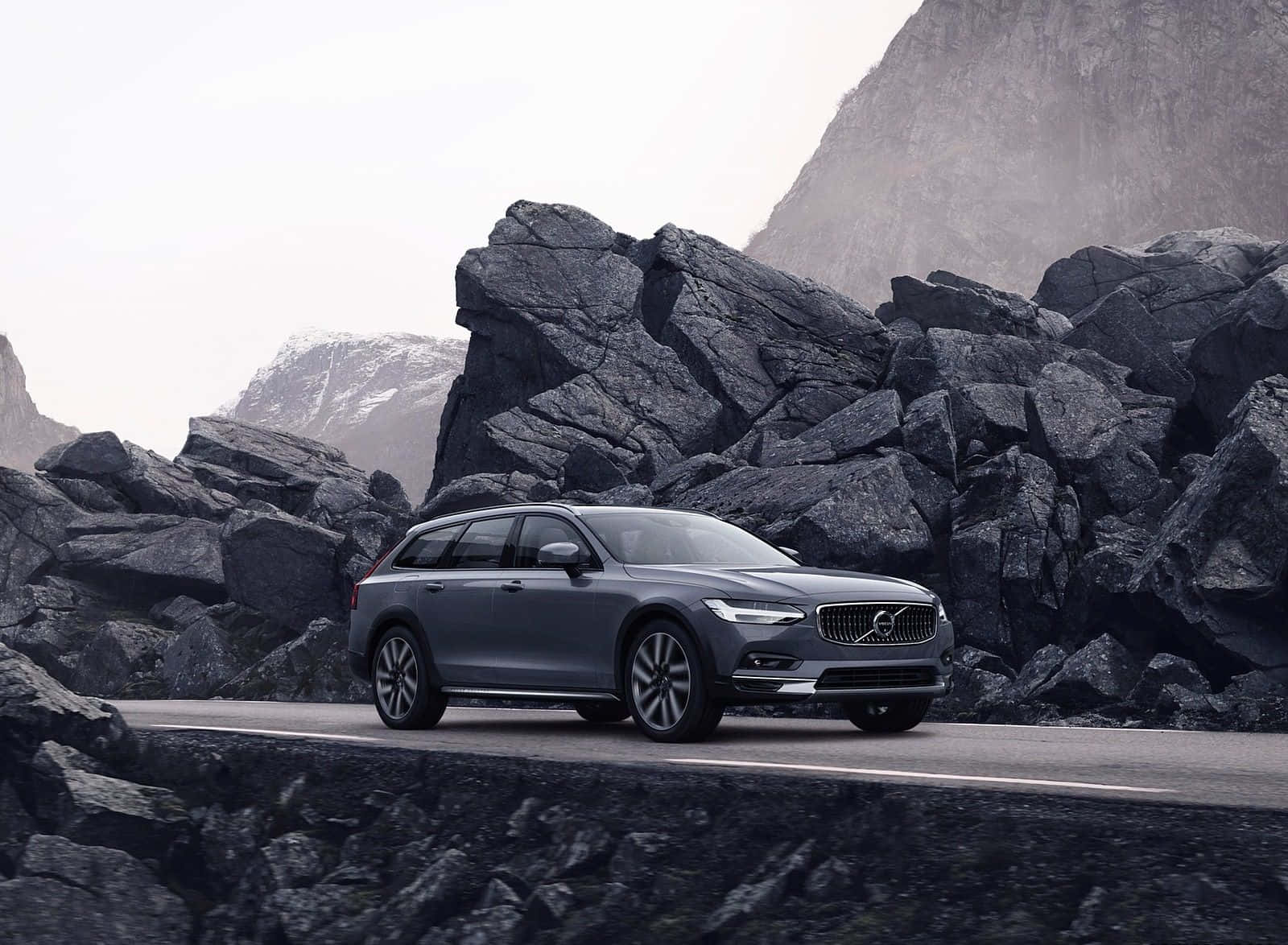 Caption: Luxurious Volvo S90 Cruising On Scenic Road Wallpaper