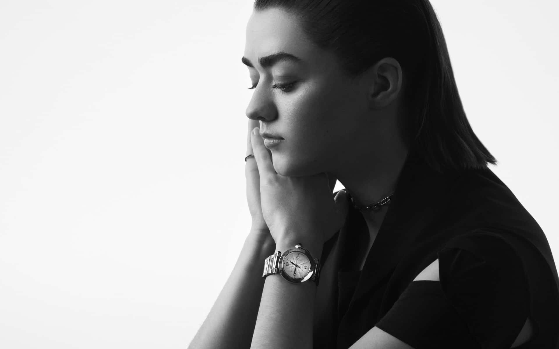 Caption: Maisie Williams Striking A Pose In An Elegant Outfit Wallpaper