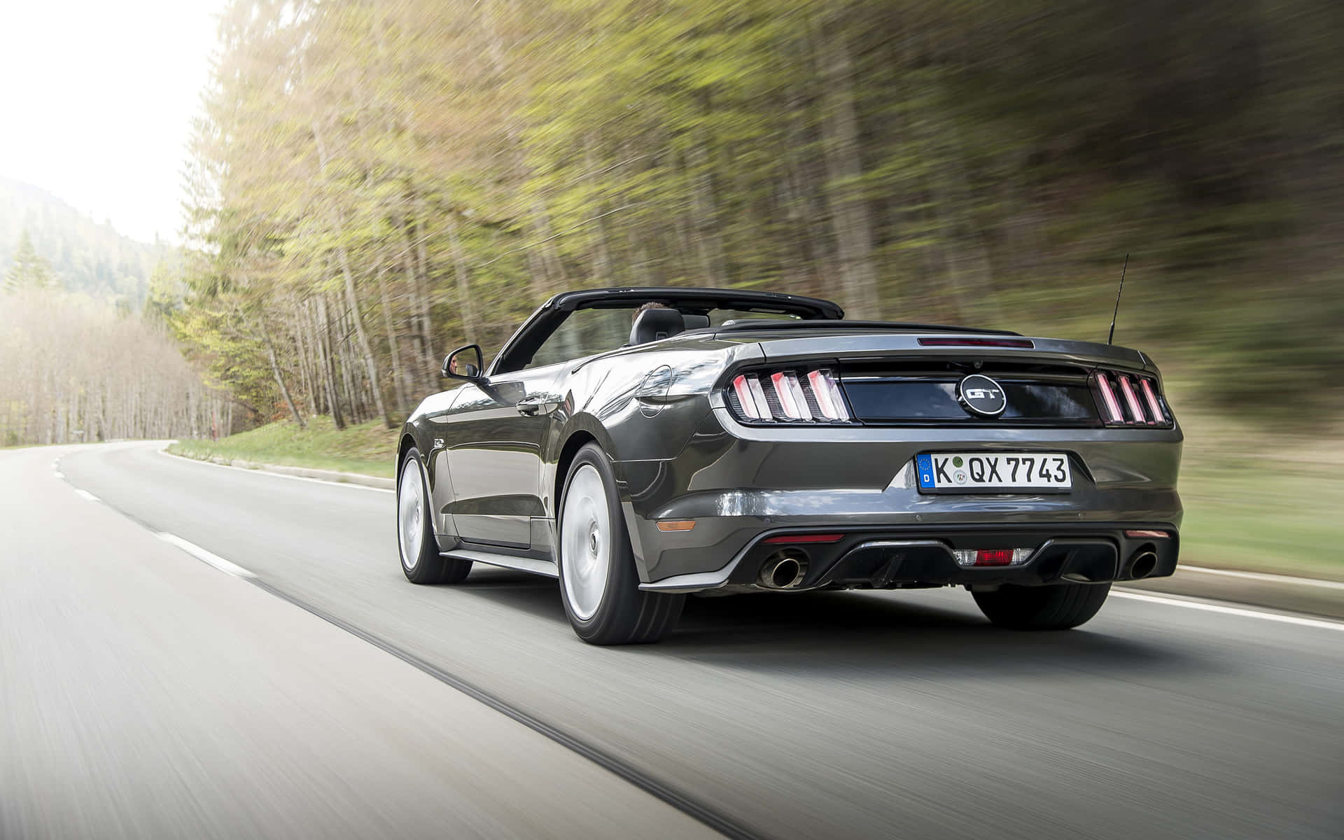 Caption: Majestic Ford Mustang Gt Convertible On The Street Wallpaper