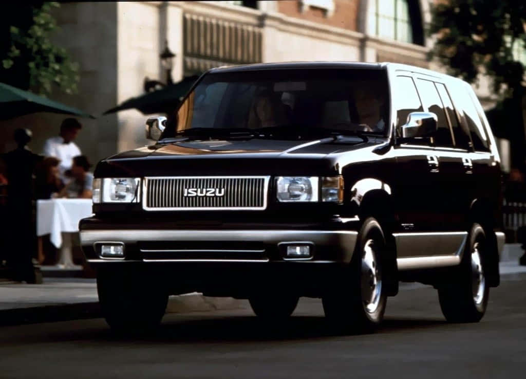 Caption: Majestic Isuzu Trooper Glowing Under Sunset Wallpaper