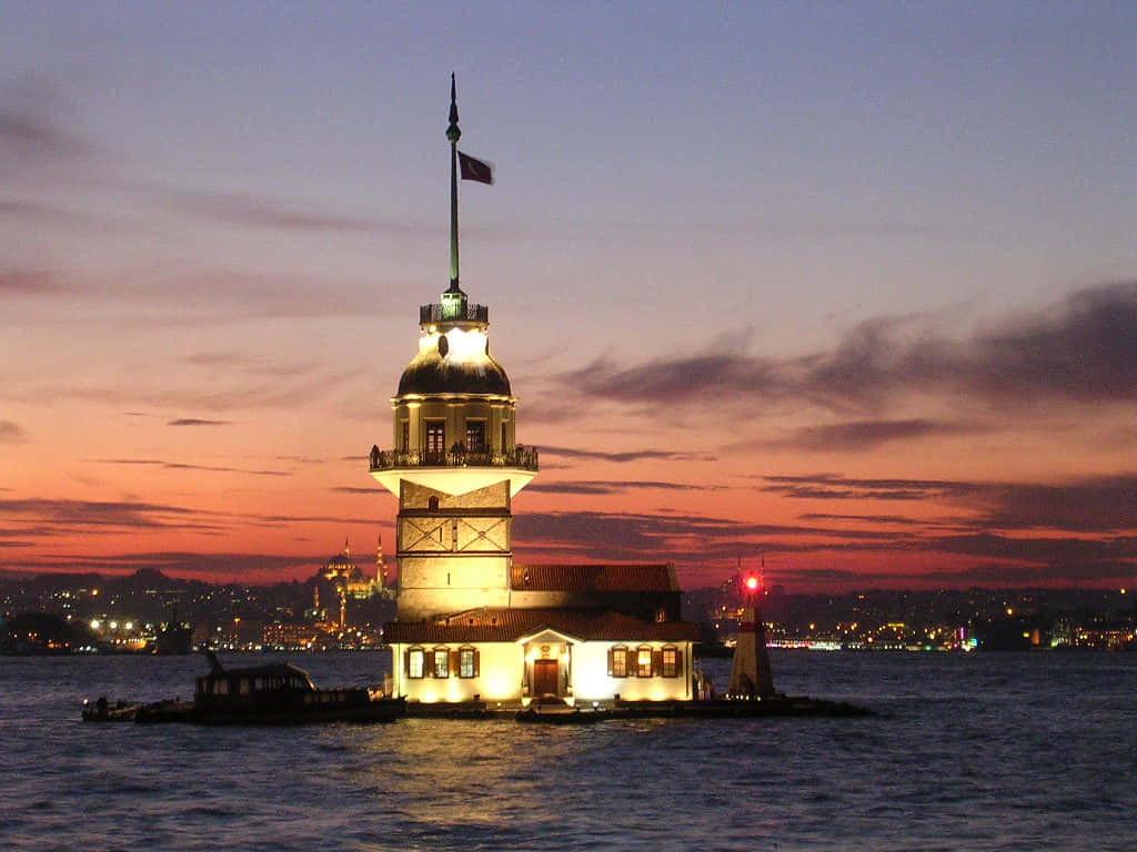 Caption: Majestic Maiden Tower Against A Spectacular Sunset Wallpaper