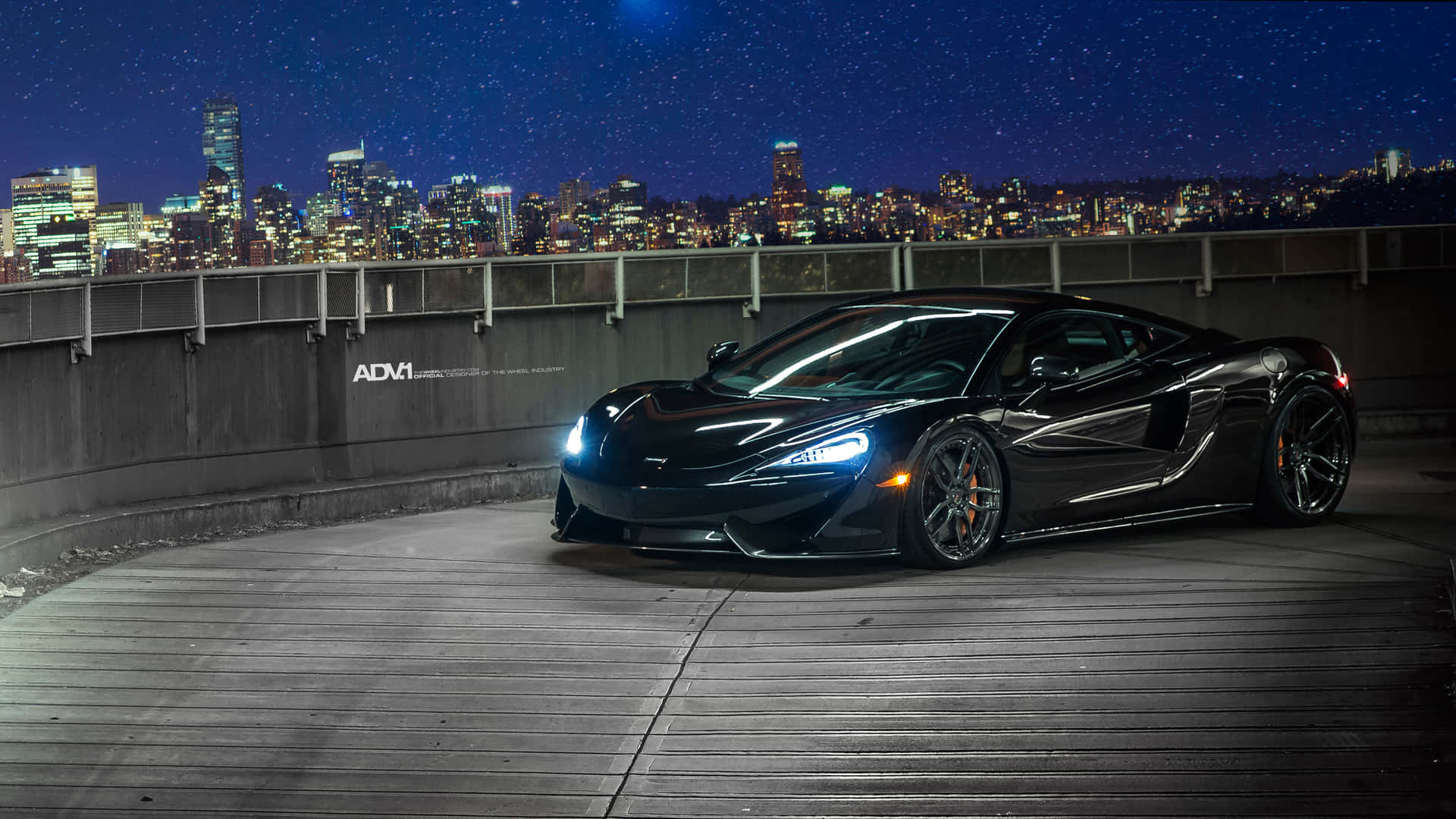 Caption: Majestic Mclaren 570s Gliding On The Road Wallpaper