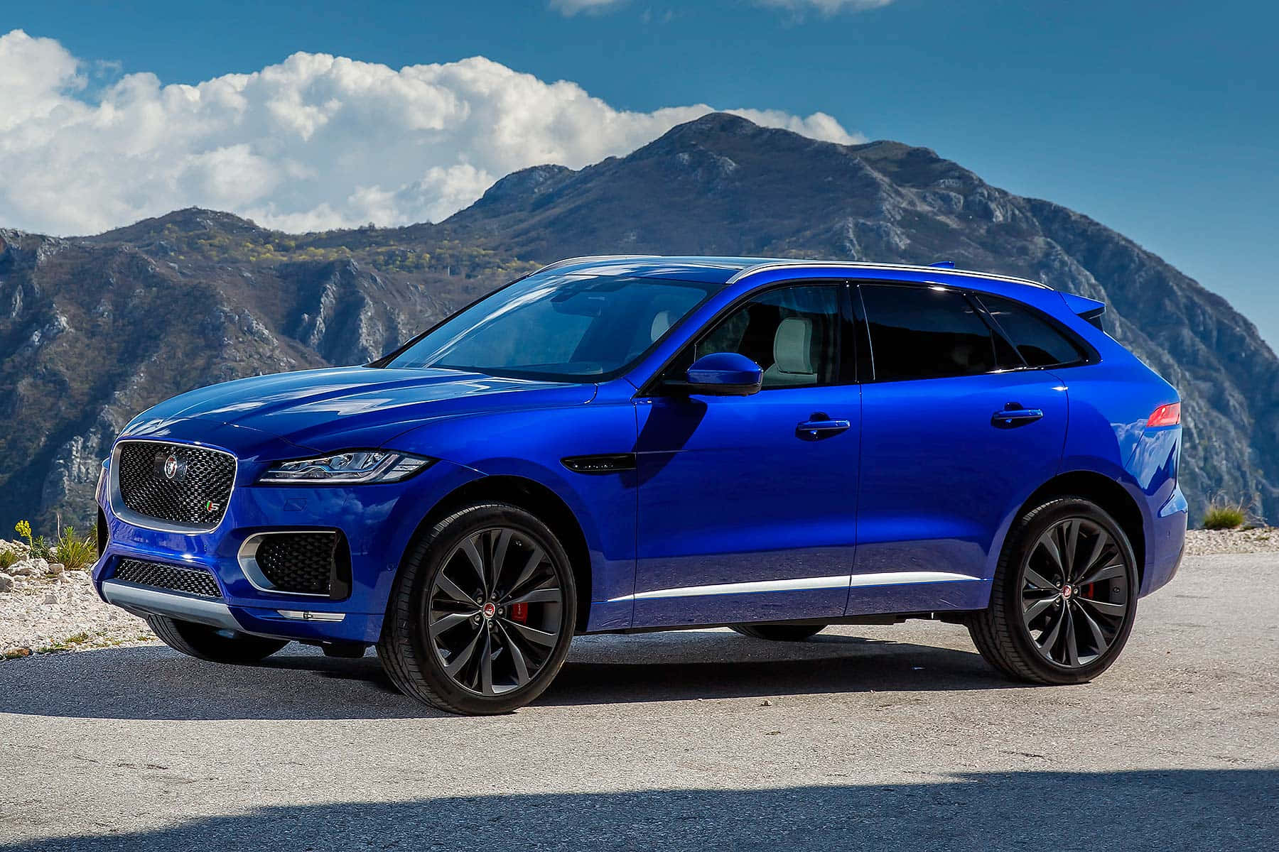 Caption: Majestic Power - Jaguar F-pace In Action Wallpaper