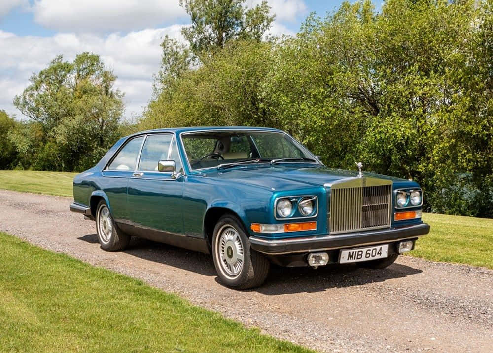 Caption: Majestic Rolls Royce Camargue In Classic Style Wallpaper