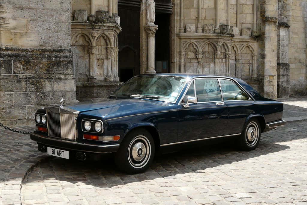 Caption: Majestic Rolls Royce Camargue In The Spotlight Wallpaper