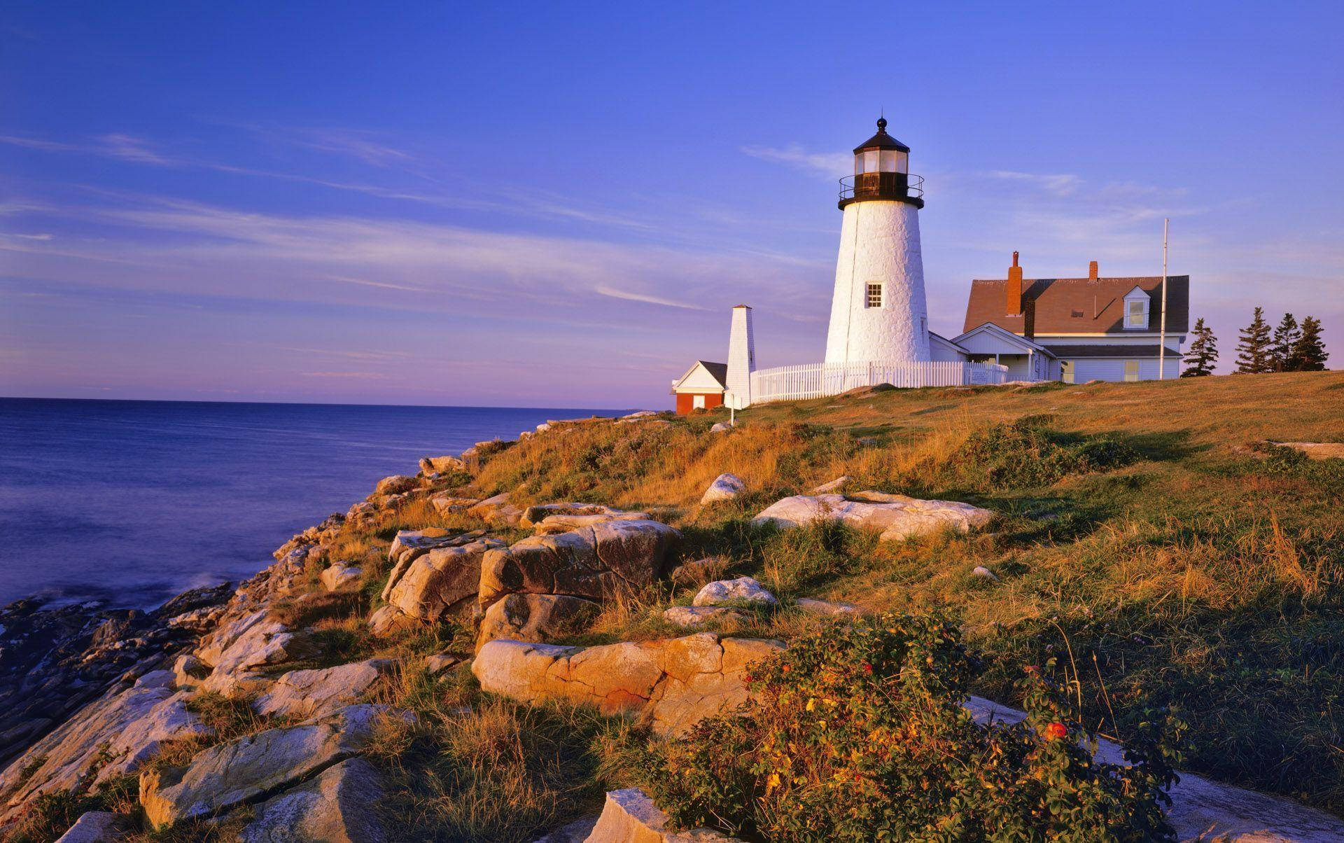 Caption: Majestic Twilight At The Lighthouse Wallpaper