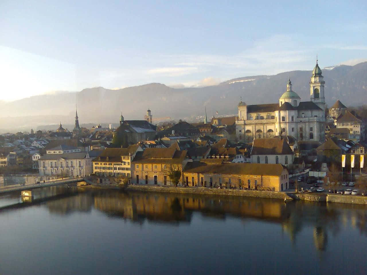 Caption: Majestic View Of Solothurn Cityscape Against Blue Sky Wallpaper