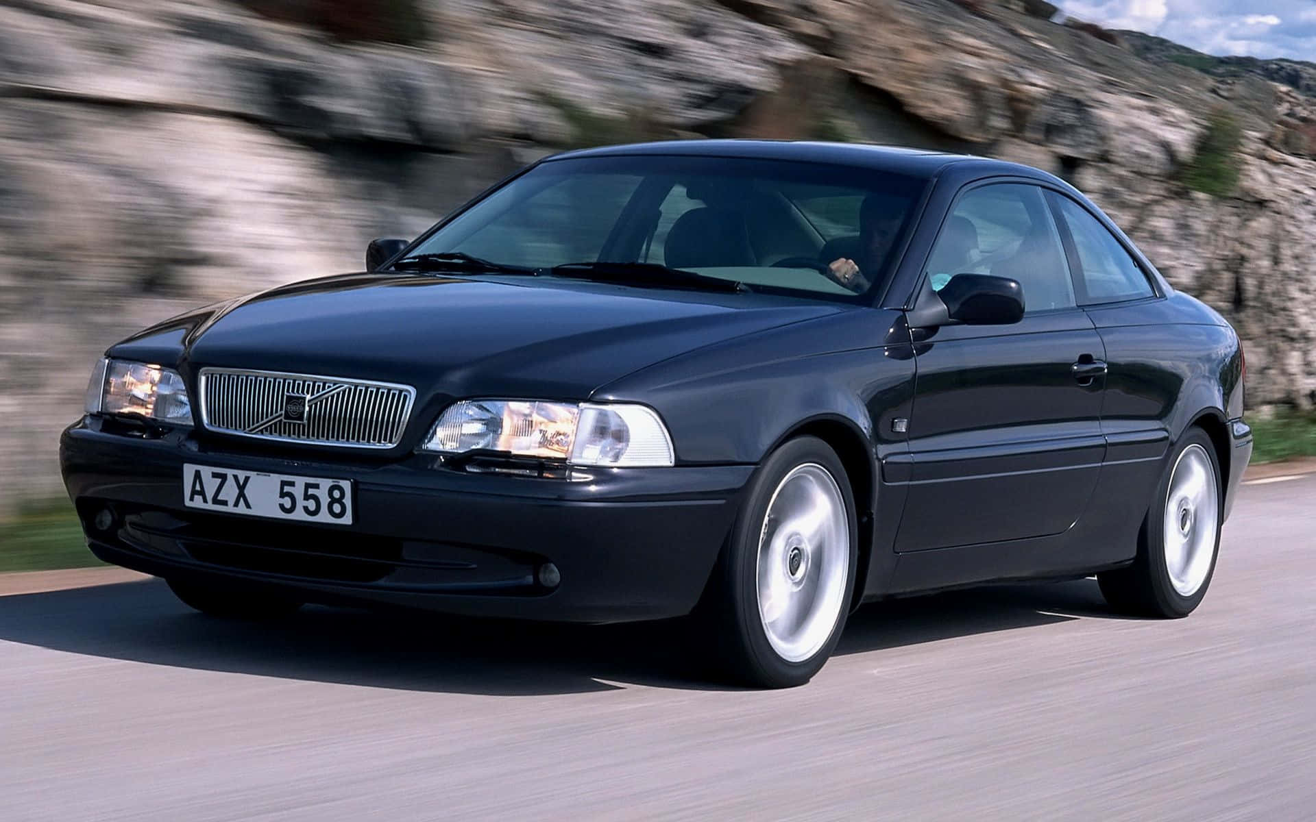 Caption: Majestic Volvo C70 Cruising The Highway Wallpaper