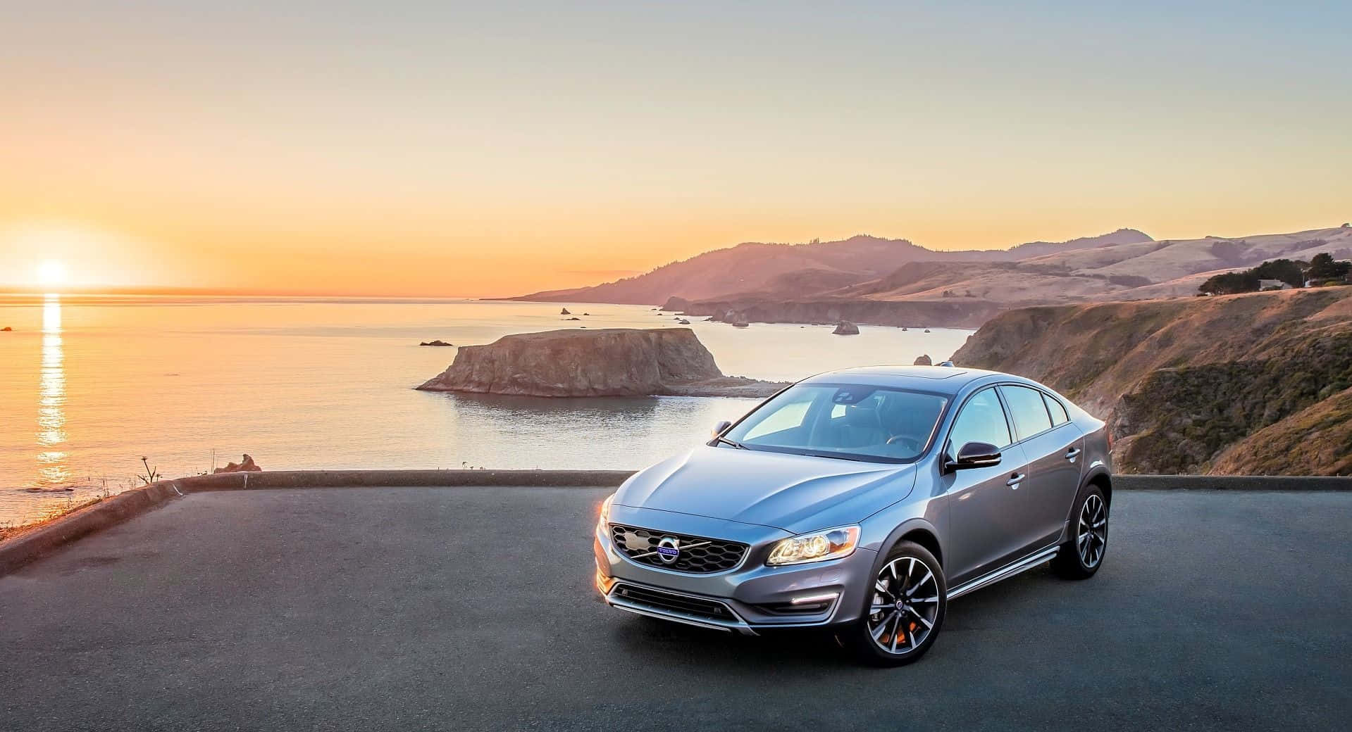 Caption: Majestic Volvo S60 Cruising On Open Road Wallpaper