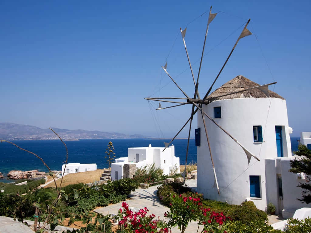 Caption: Mesmerizing Mykonos Windmills At Sunset Wallpaper