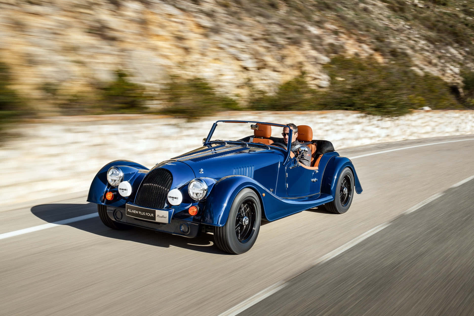 Caption: Mighty And Agile Morgan Plus Four On Open Road Wallpaper