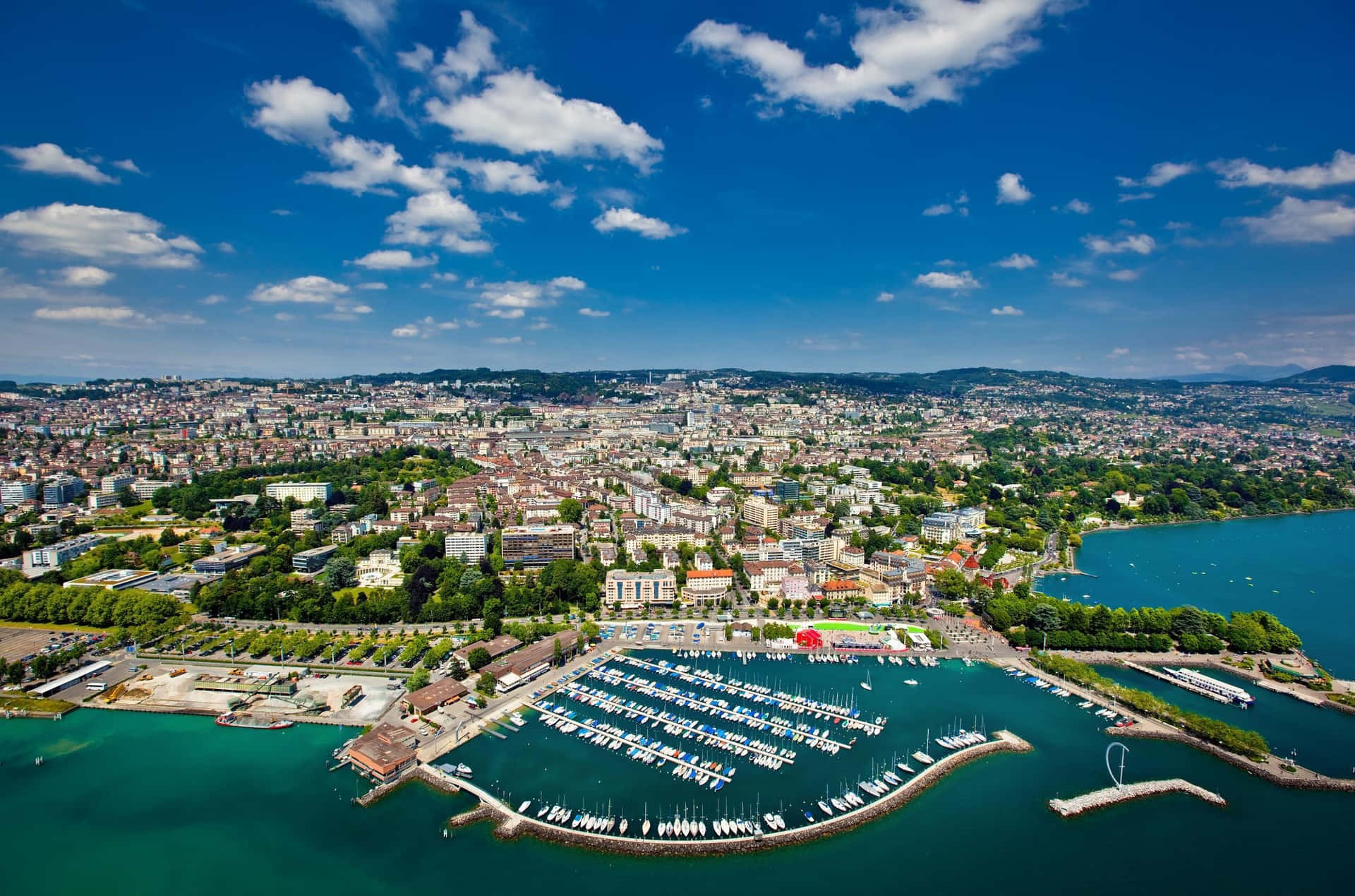 Caption: Panoramic View Of Lausanne Cityscape At Sunset Wallpaper