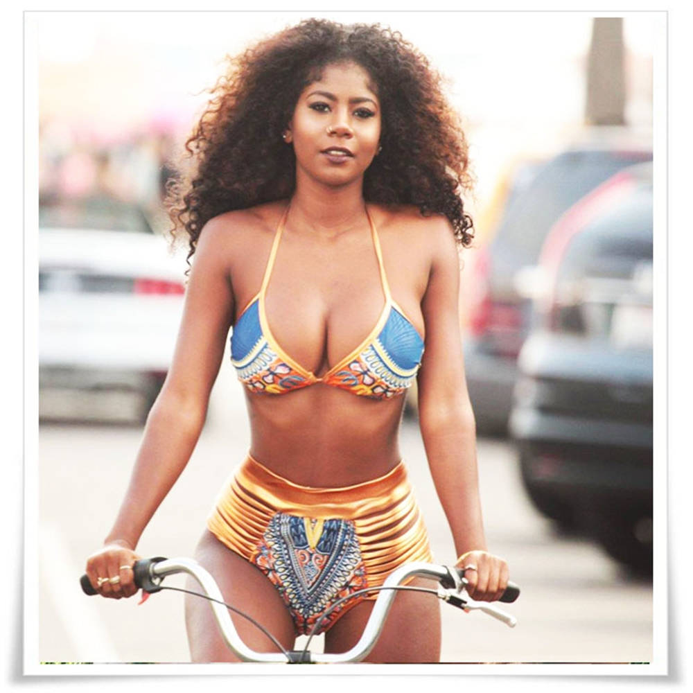 Caption: Picturing Elegance: A Graceful Black Woman Enjoys The Beach Wallpaper