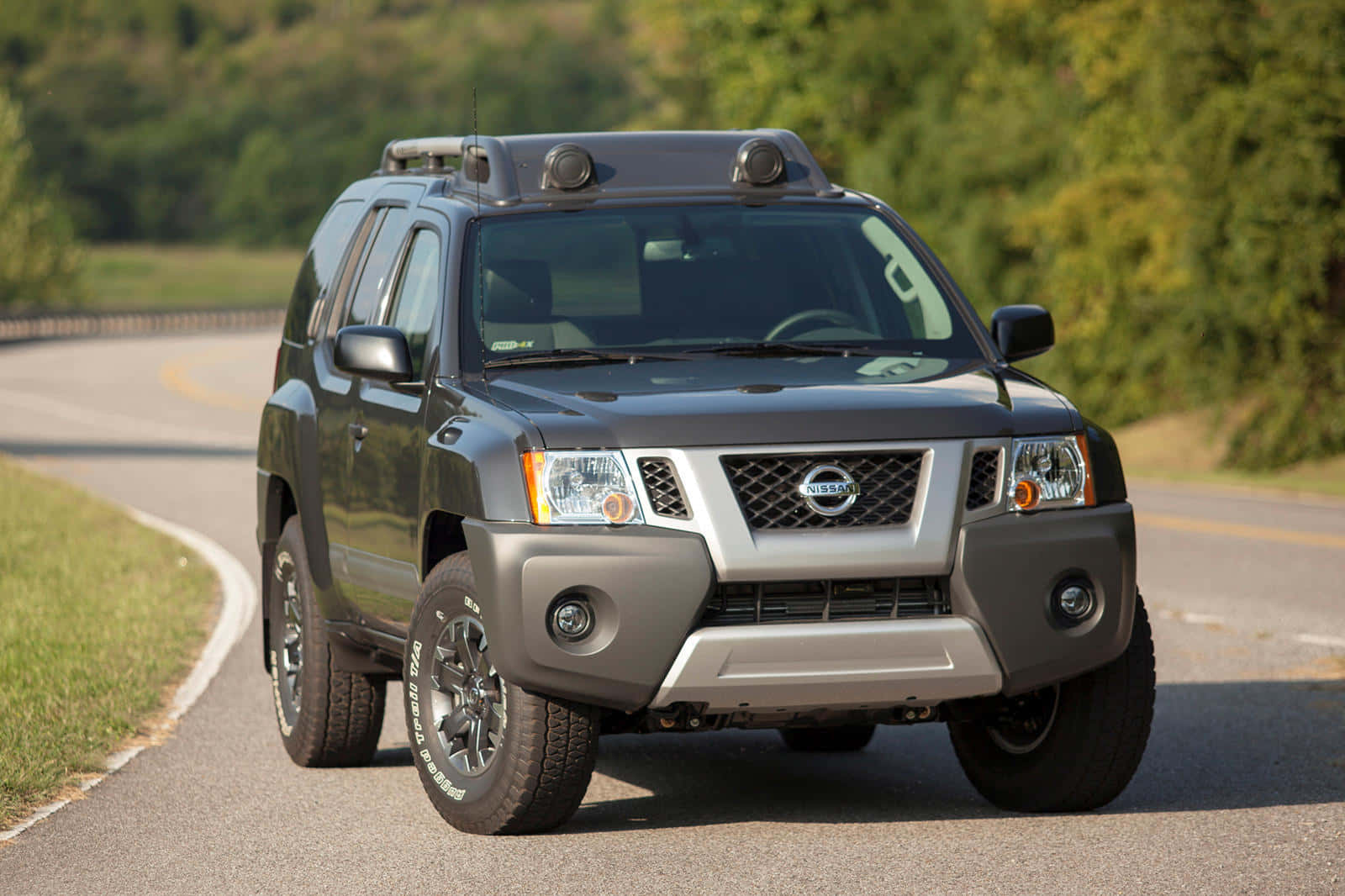 Caption: Robust Nissan Xterra Cruising In Wilderness Wallpaper