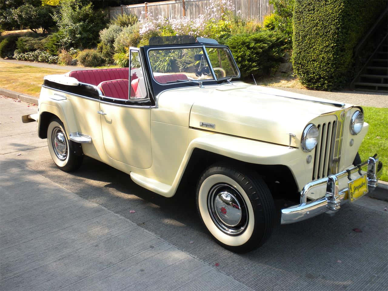 Caption: Rugged Adventure Jeepster In Natural Landscape Wallpaper