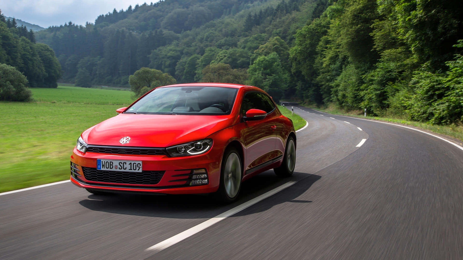 Caption: Sleek And Classy Volkswagen Scirocco On Road Wallpaper