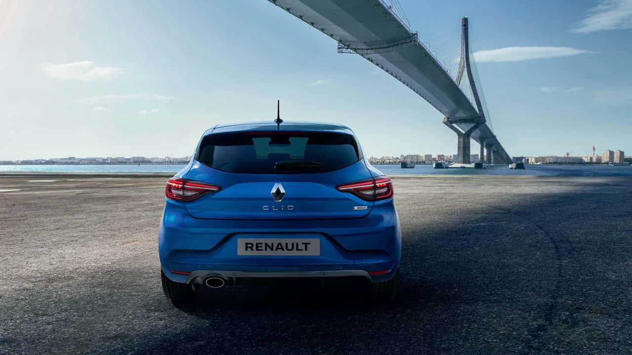 Caption: Sleek And Modern Renault Clio On A Picturesque Road Wallpaper