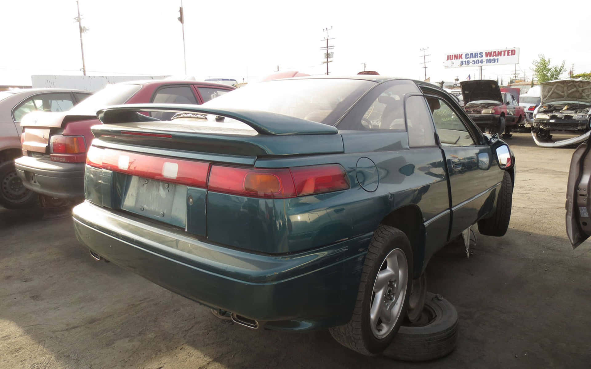 Caption: Sleek And Shiny Subaru Svx On Highway Wallpaper