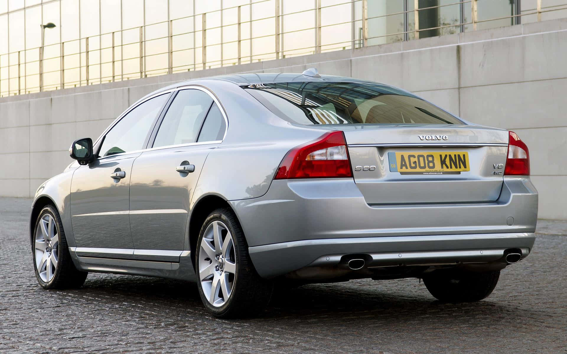 Caption: Sleek And Stylish Volvo S80 On Road Wallpaper