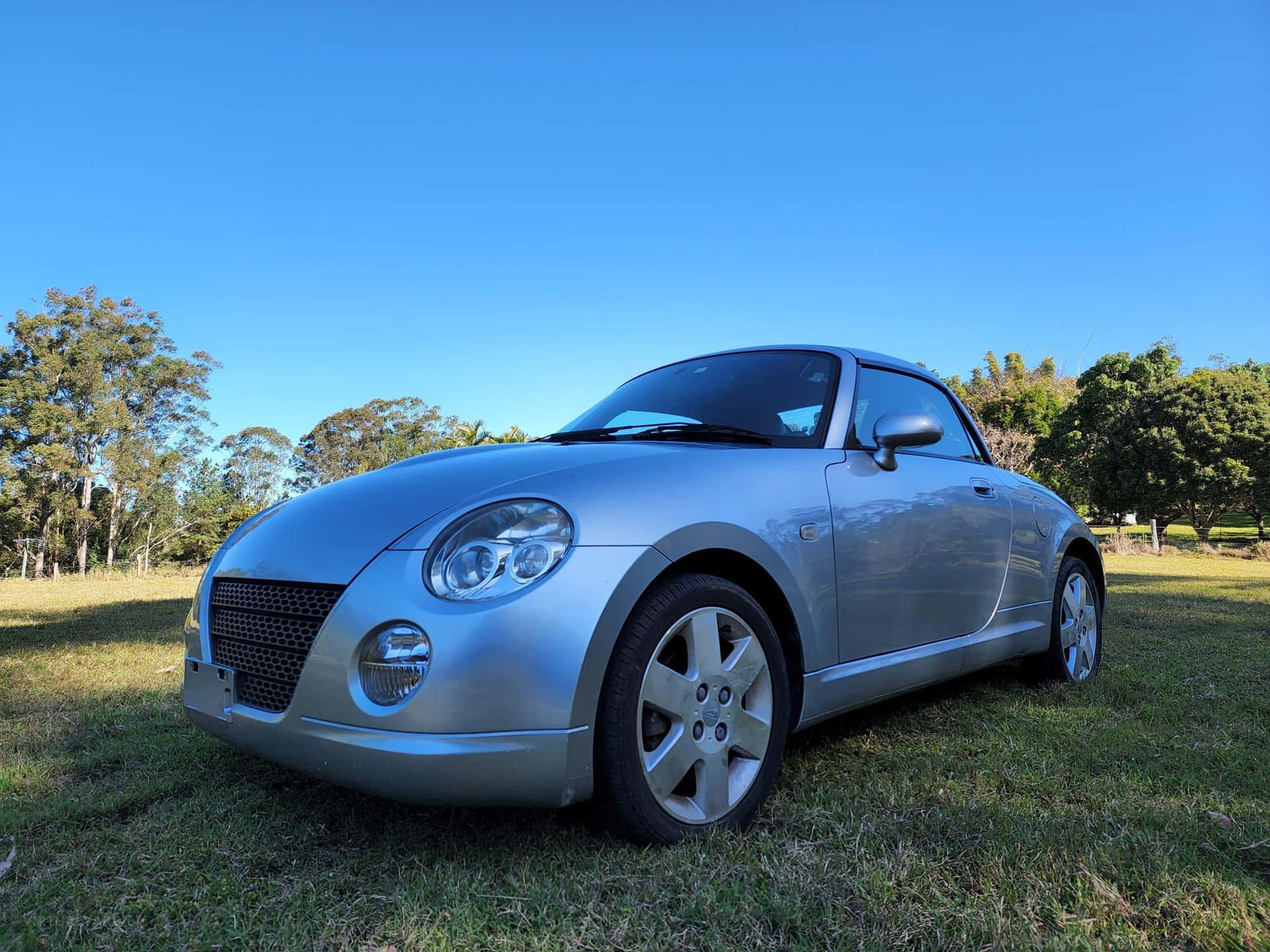 Caption: Sleek Daihatsu Copen Under The Golden Sunset Wallpaper