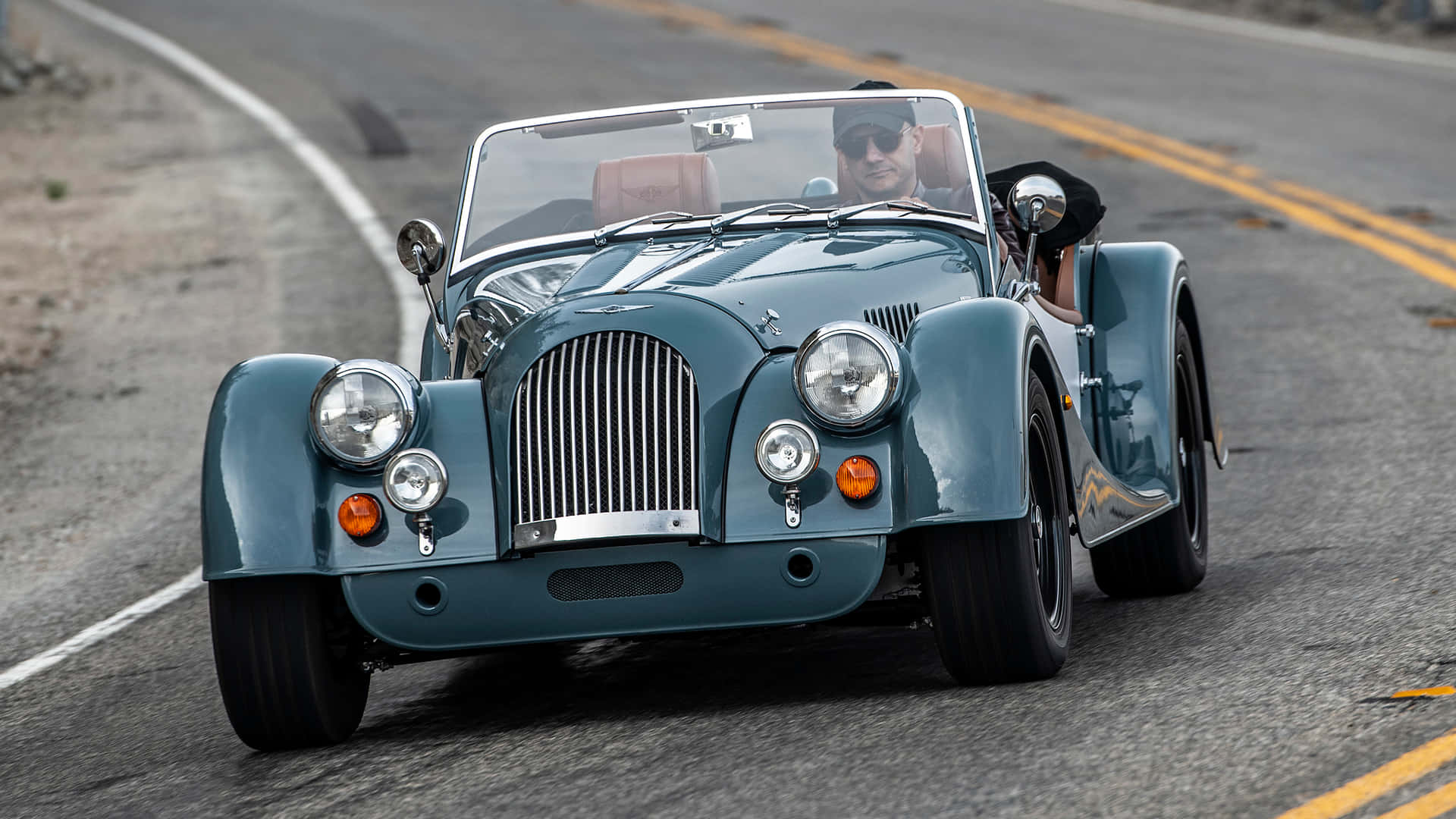 Caption: "sleek Design Of The Morgan Plus Four On The Open Road" Wallpaper