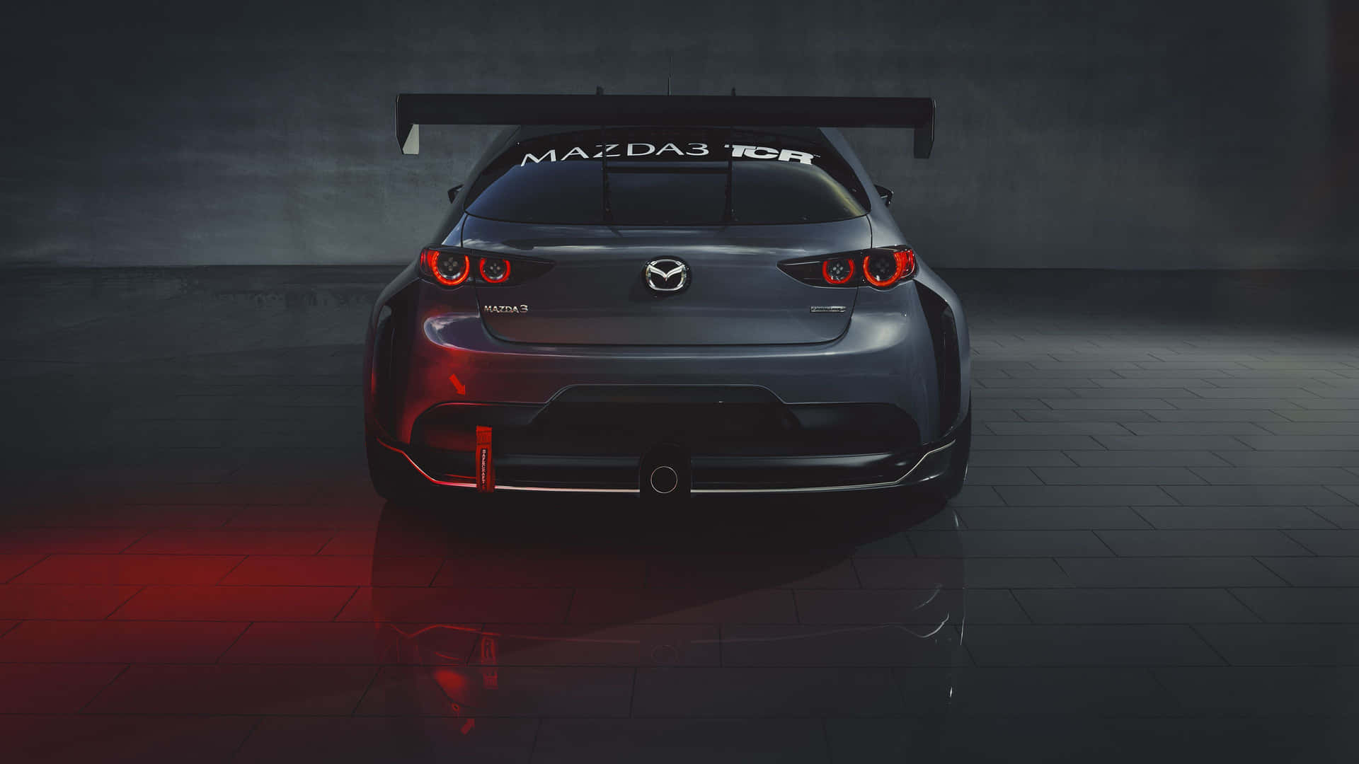 Caption: Sleek Mazda 3 Hatchback Cruising On The Highway Wallpaper