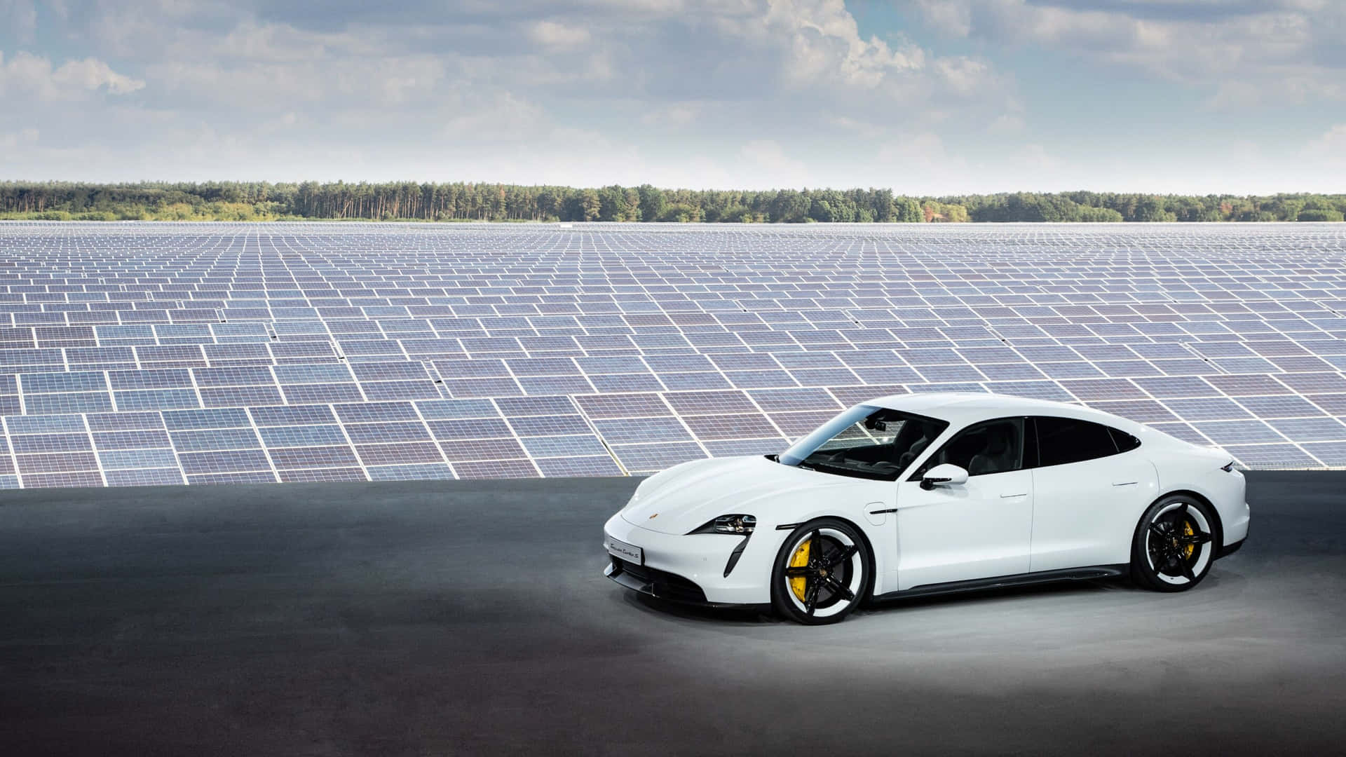Caption: Sleek Porsche Taycan Charging On The Streets Wallpaper
