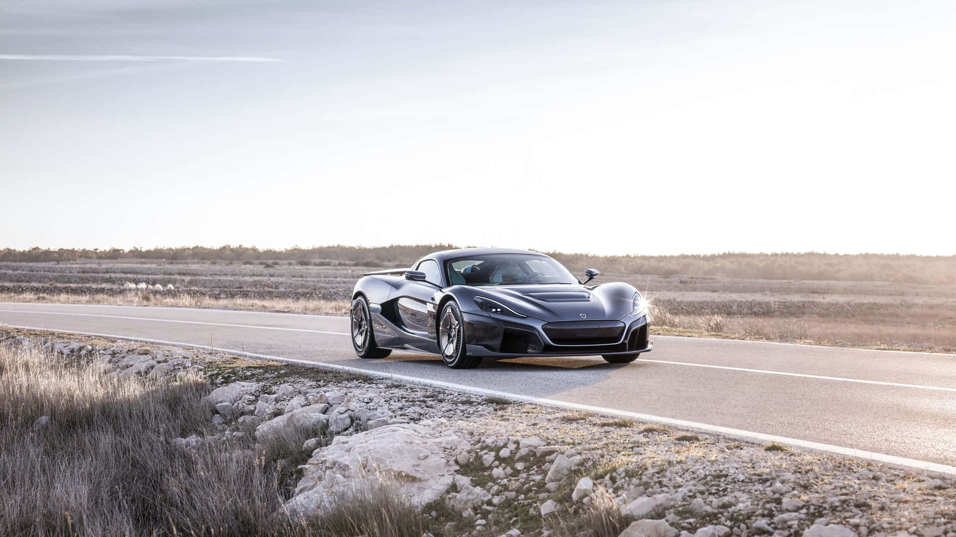 Caption: Sleek Rimac C Two Gliding On A Country Road Wallpaper