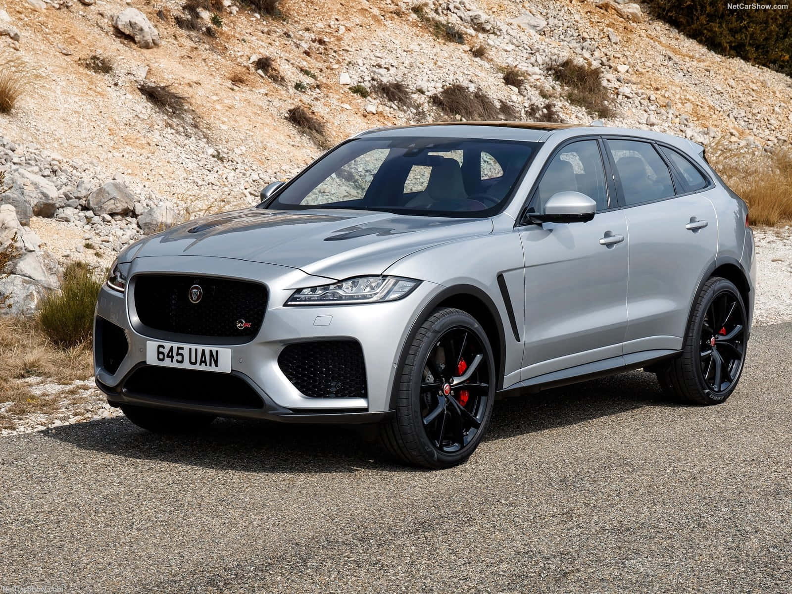 Caption: Sleek Silver Jaguar F-pace On City Streets Wallpaper