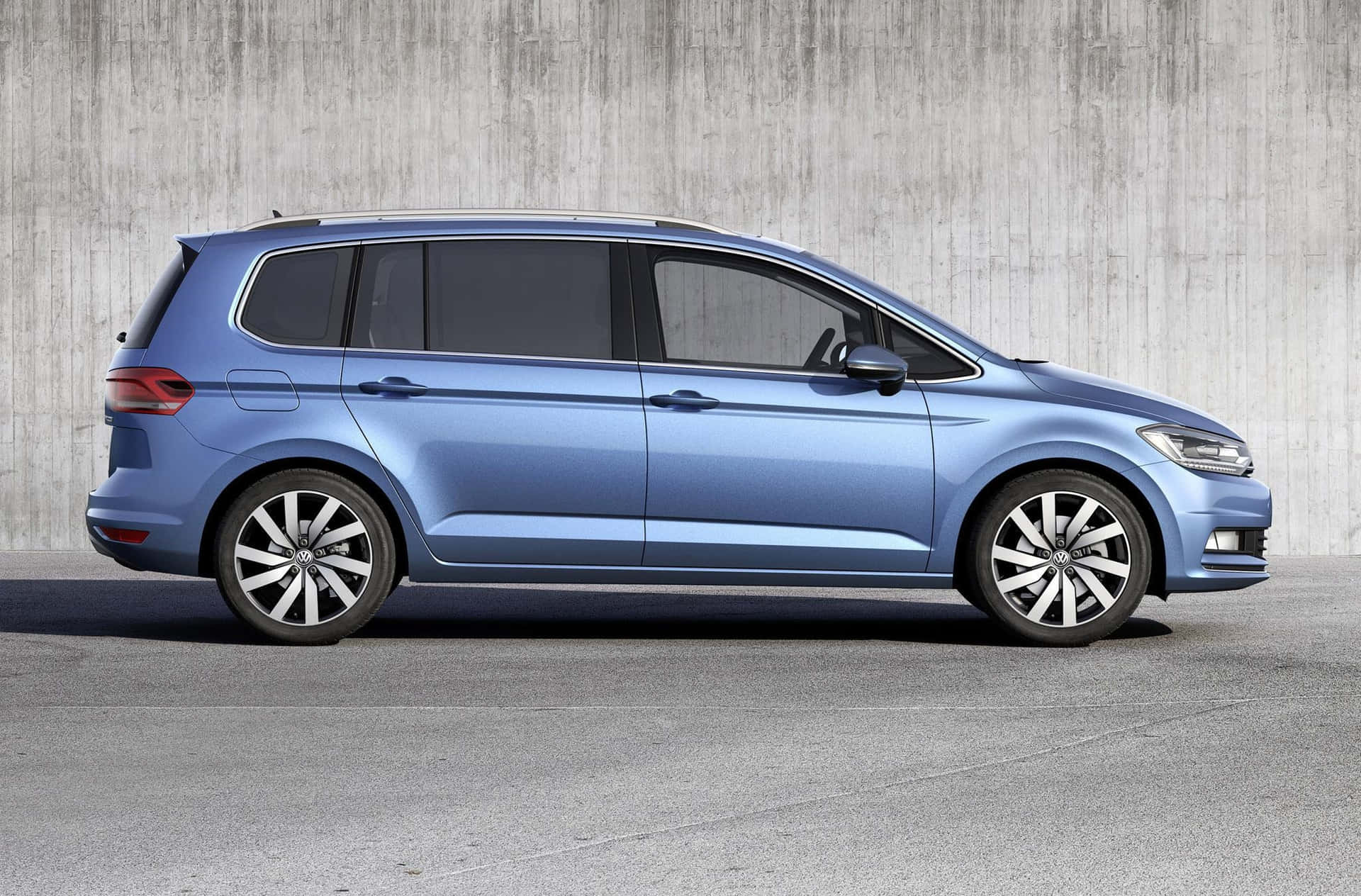 Caption: Sleek Volkswagen Touran On An Untraveled Highway Wallpaper