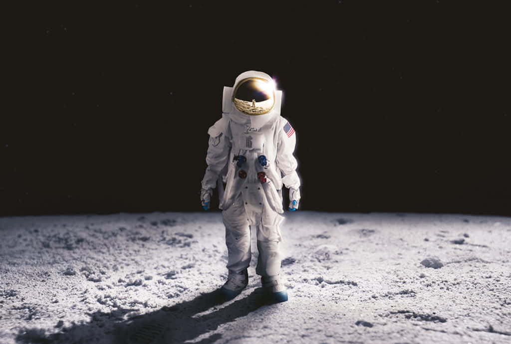 Caption: Solitude In Space - Astronaut Exploring The Moon’s Terrain. Wallpaper