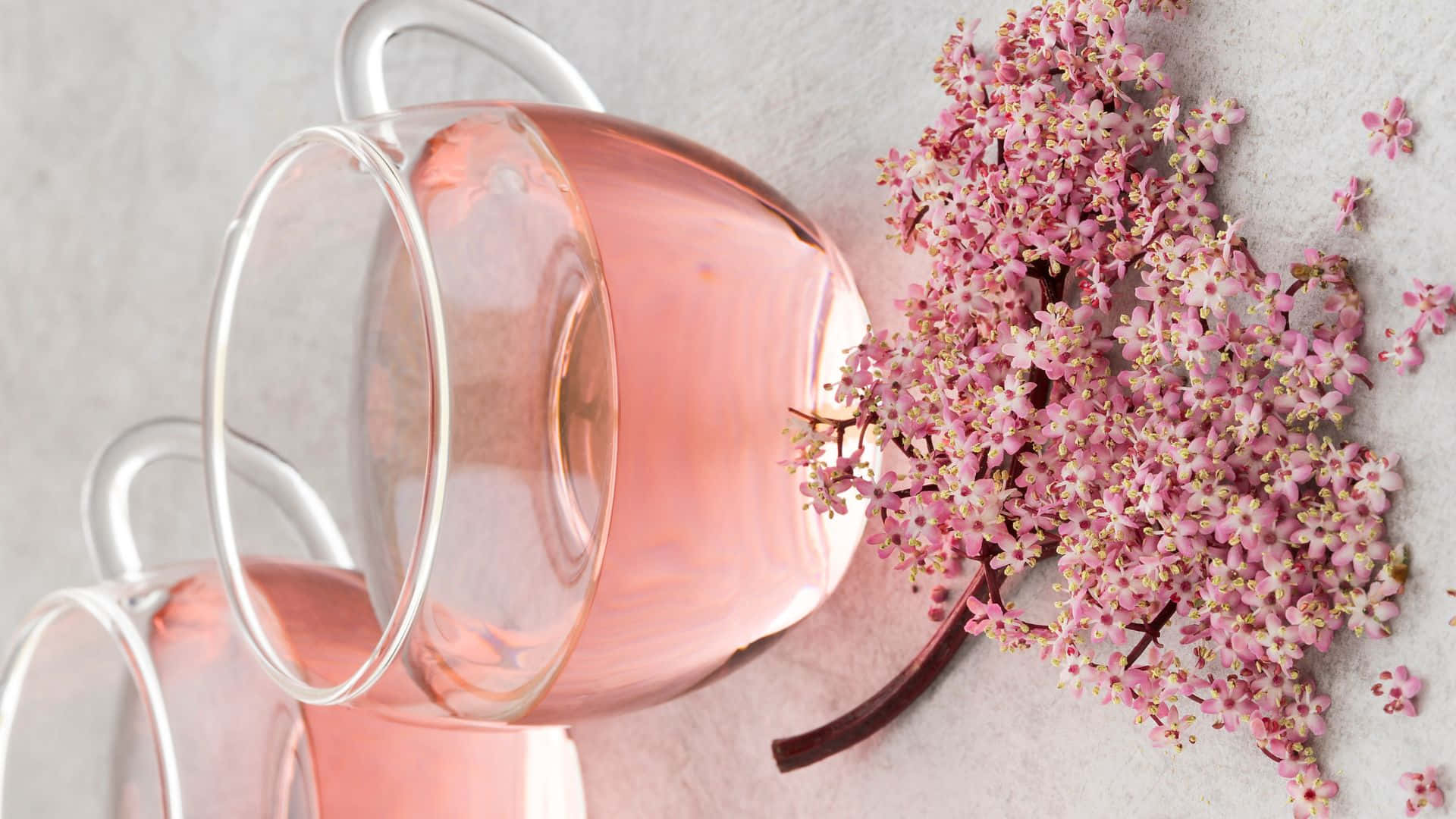 Caption: Soothing Pink Tea In A Transparent Teacup Wallpaper
