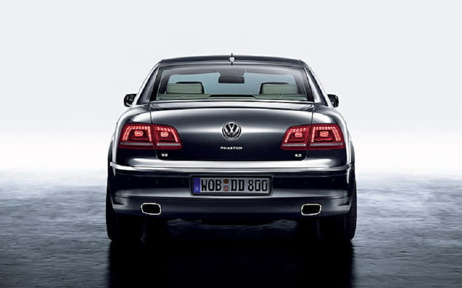 Caption: Sophisticated Volkswagen Phaeton Cruising On An Urban Road Wallpaper