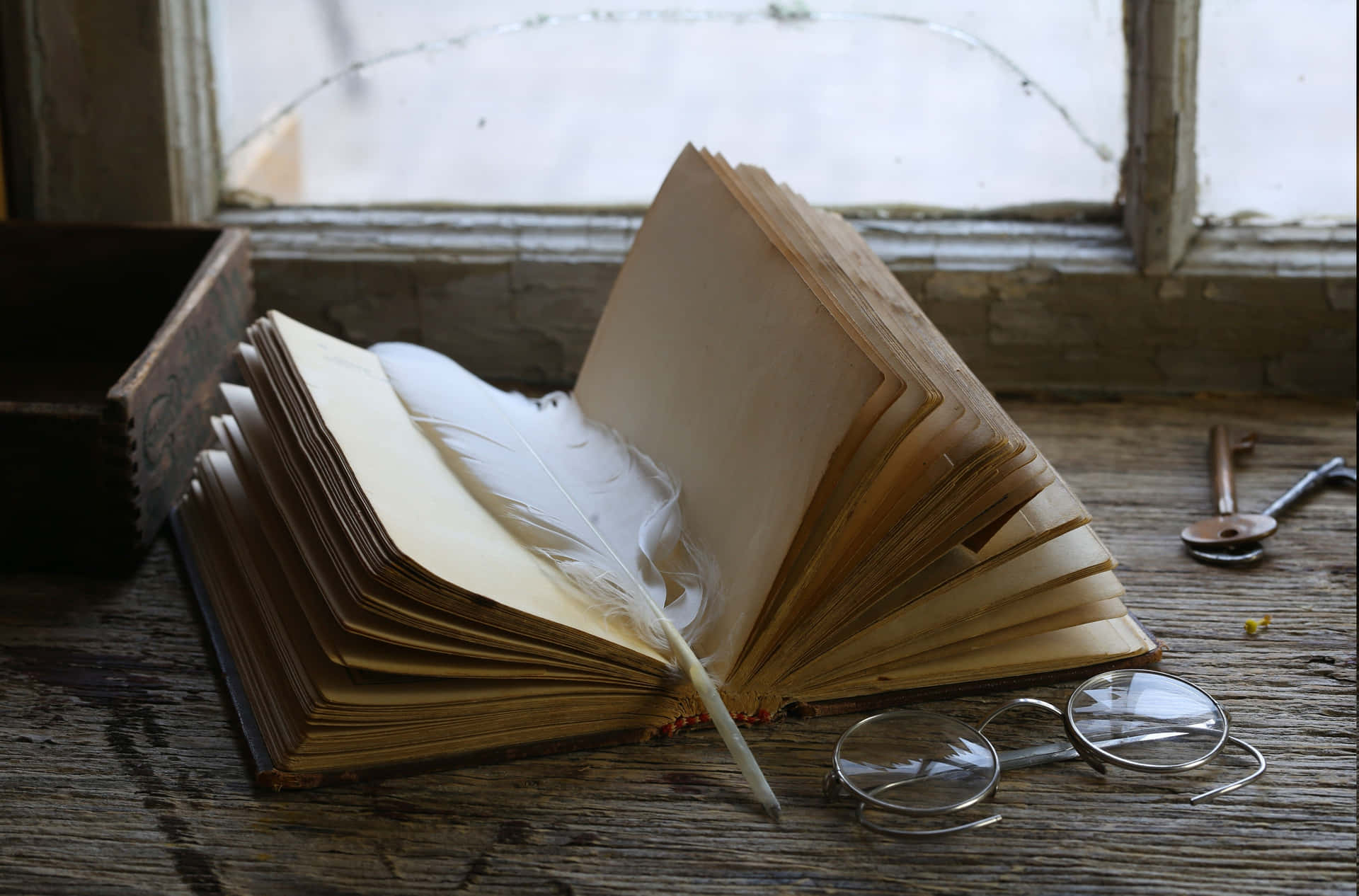 Caption: "stack Of Antique Books With A Vintage Magnifying Glass" Wallpaper