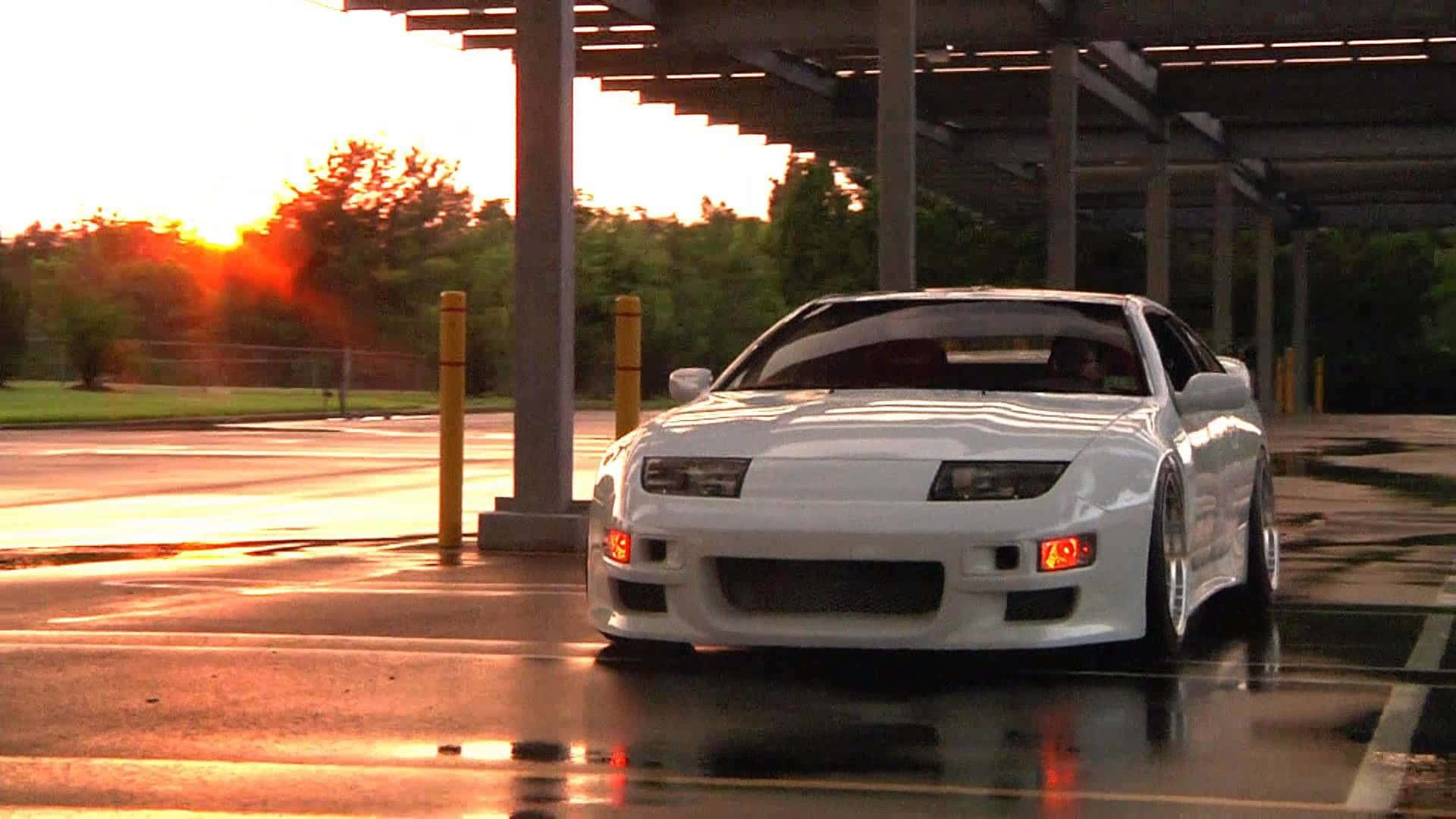 Caption: Striking Nissan 300zx Cruising At Sunset Wallpaper