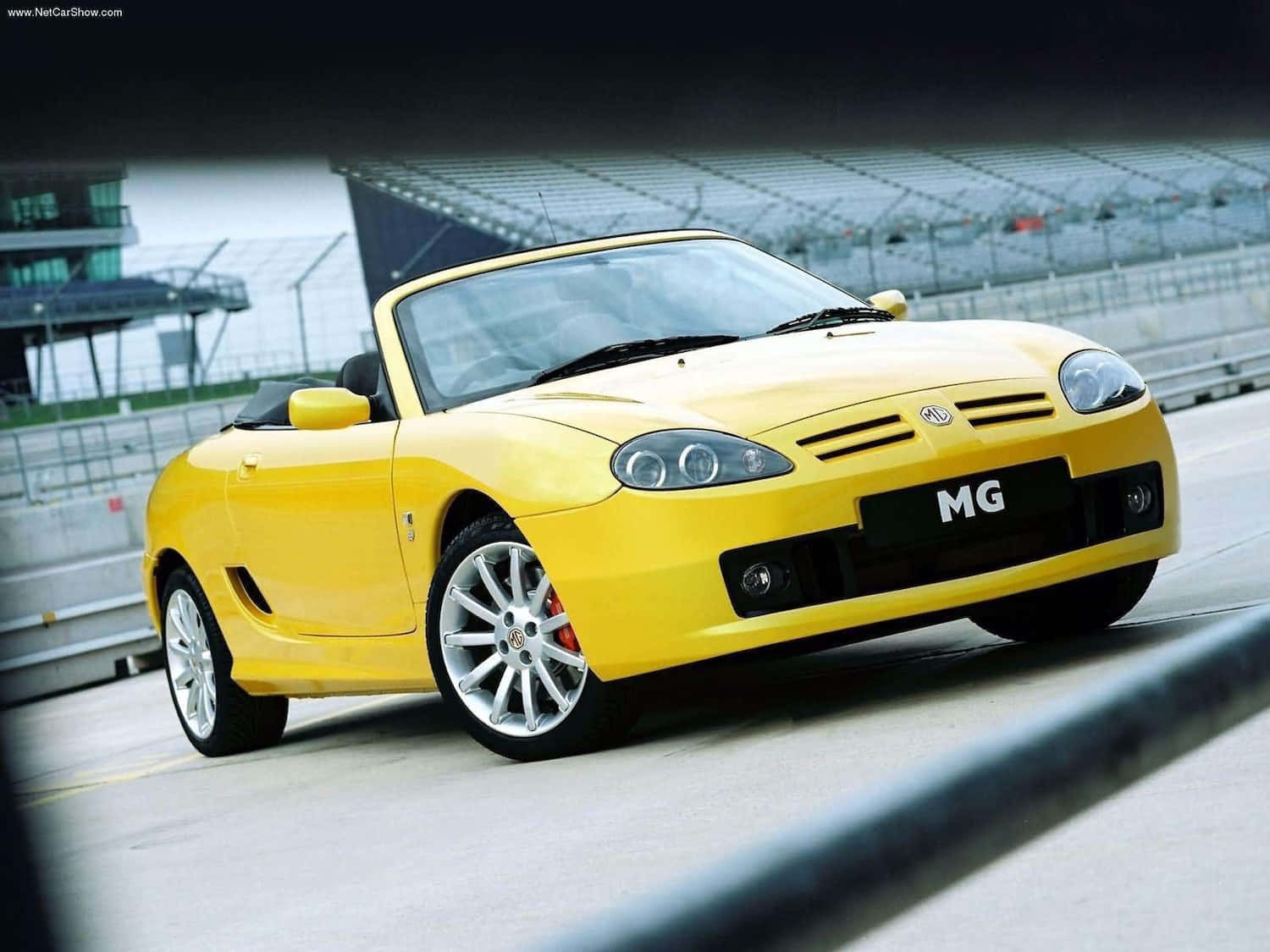 Caption: Stunning Mg Tf Against A Vibrant Natural Backdrop Wallpaper