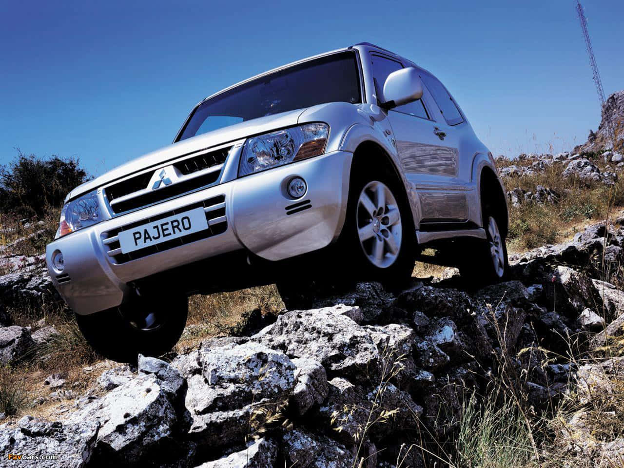 Caption: Stunning White Mitsubishi Pajero Rolling Down On A Country Road Wallpaper