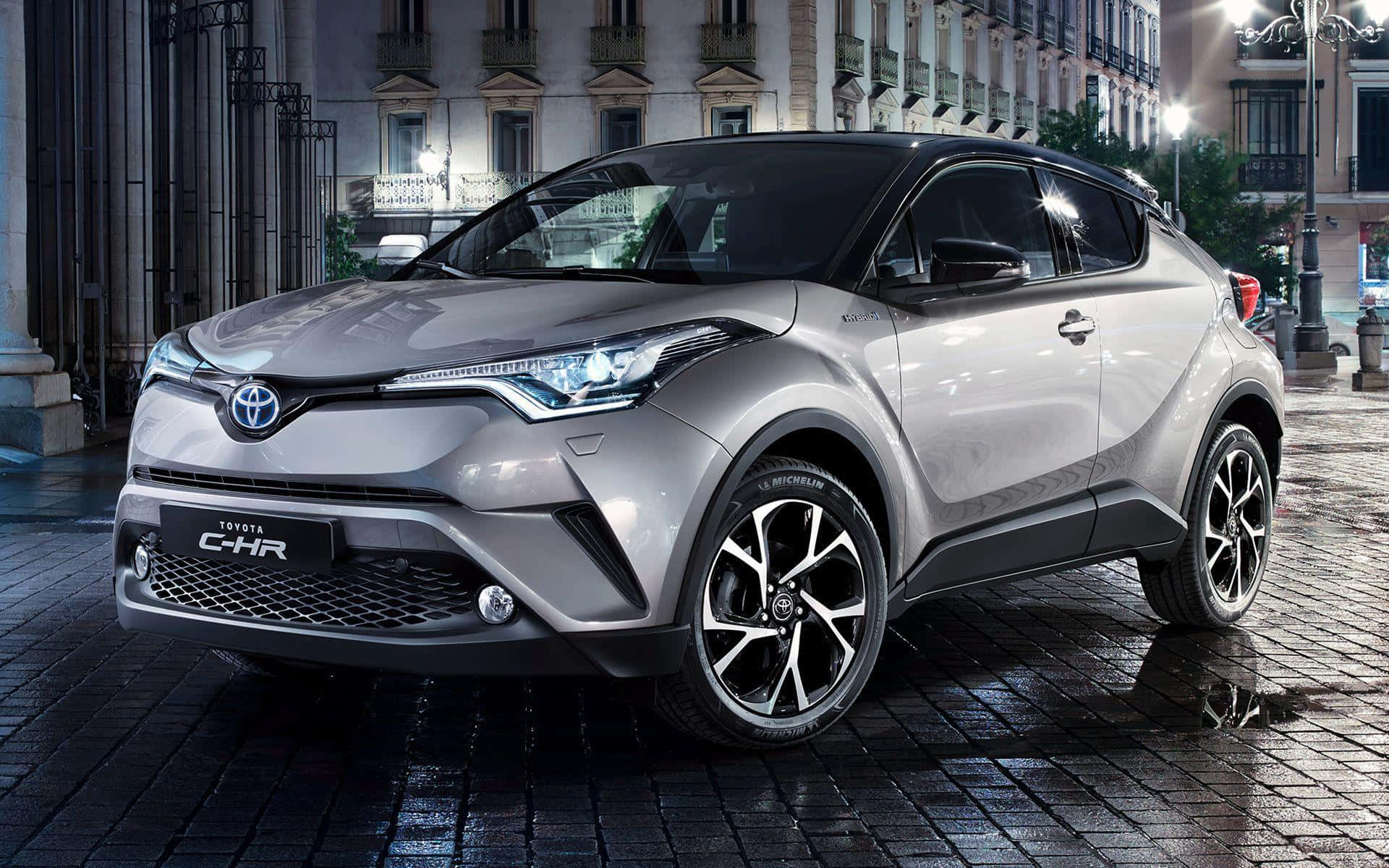 Caption: Stylish And Dynamic Toyota C-hr In Vibrant City Background Wallpaper