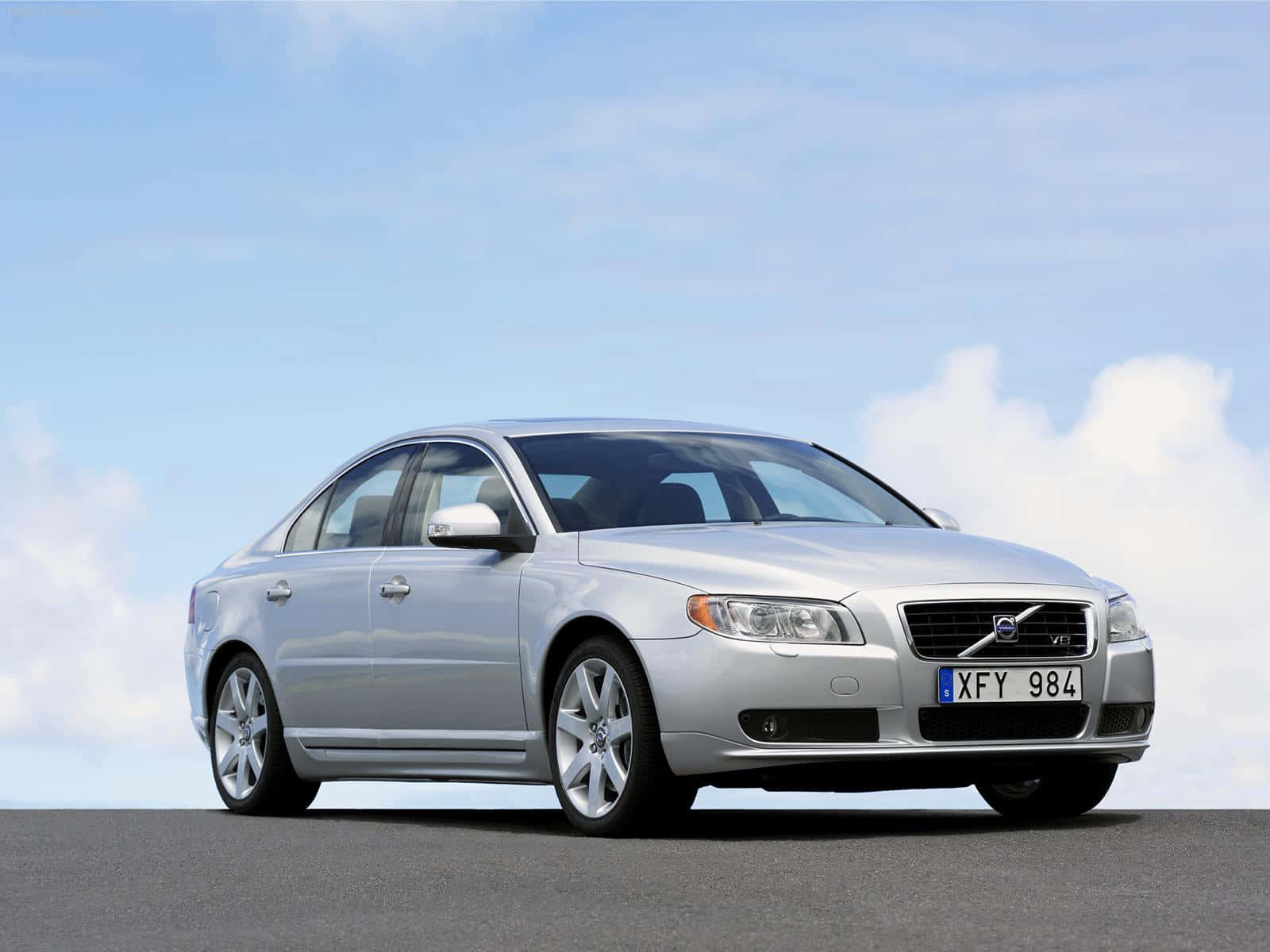 Caption: Stylish And Refined Volvo S80 In A Scenic Cityscape Wallpaper