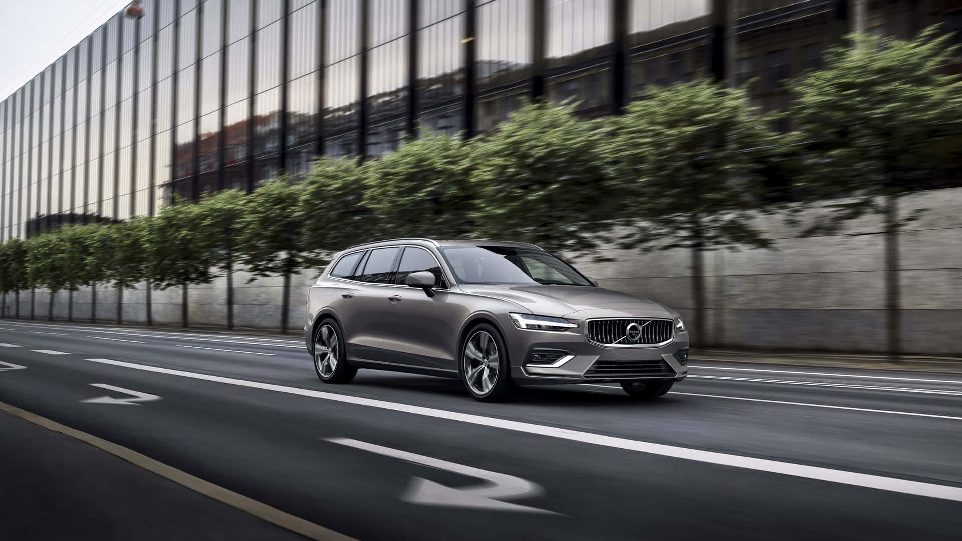 Caption: Stylish And Sophisticated - Volvo V60 On A Scenic Road Wallpaper