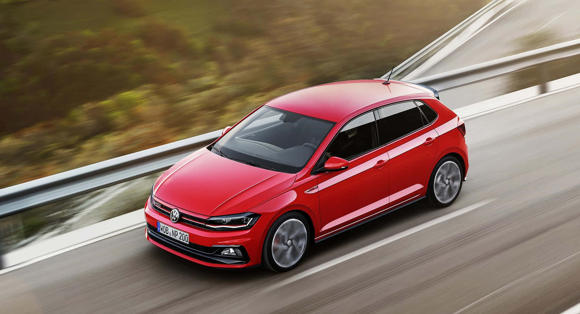 Caption: Stylish Volkswagen Polo Gliding Down The Road Wallpaper