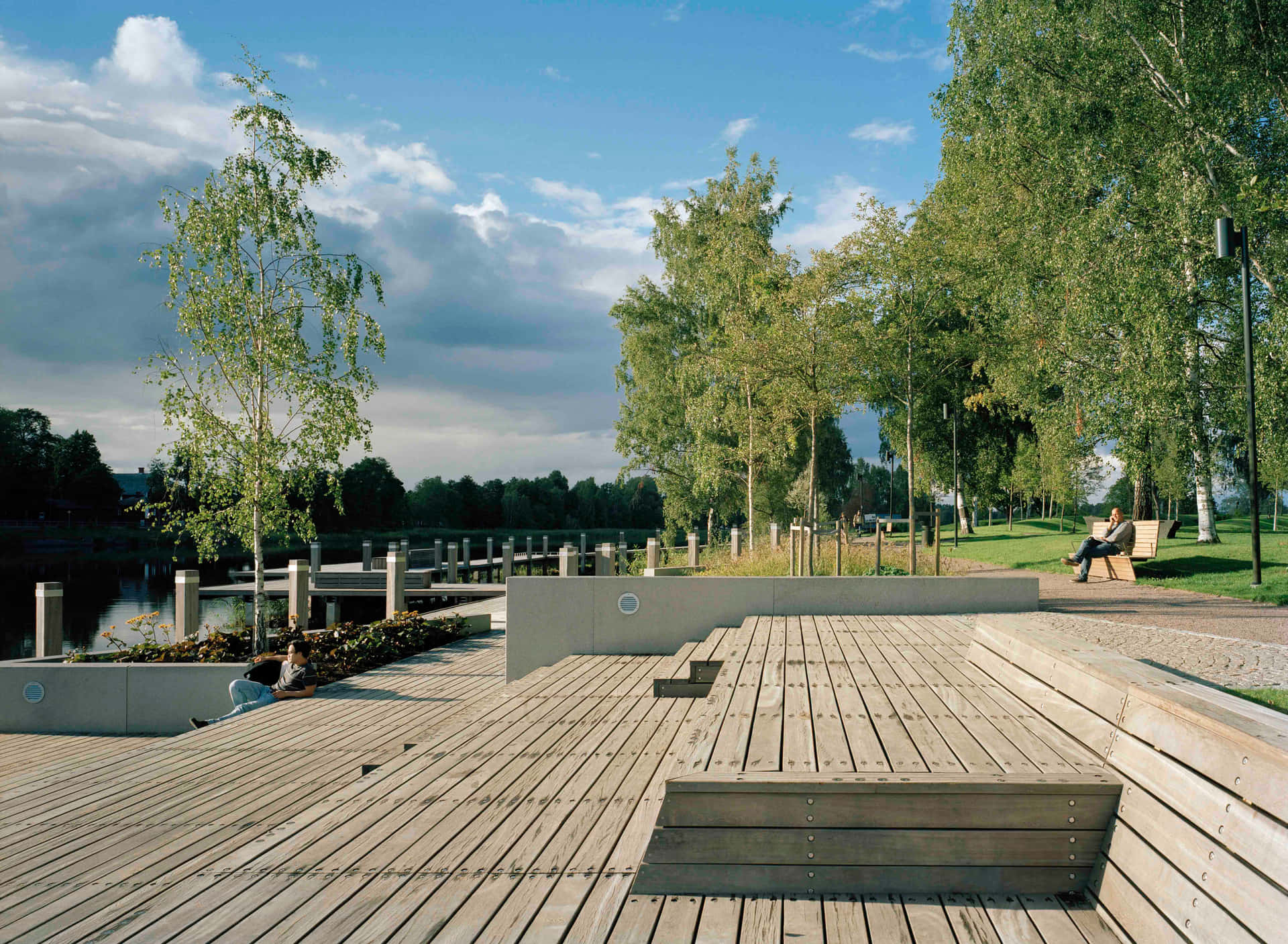 Caption: Sunlit Waterfront View Of Karlstad, Sweden Wallpaper