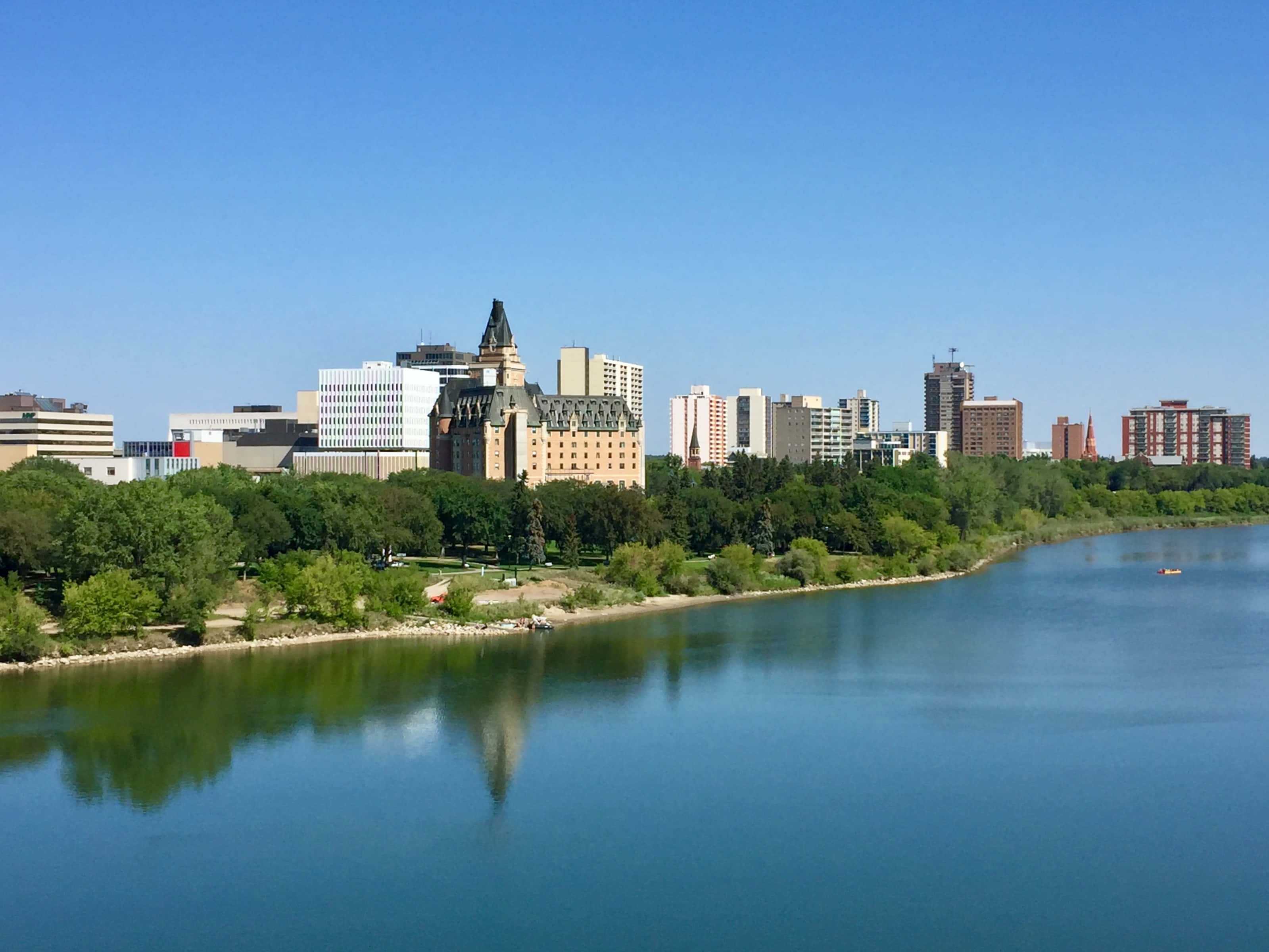 Caption: Sunny Day At The Saskatoon Skyline Wallpaper