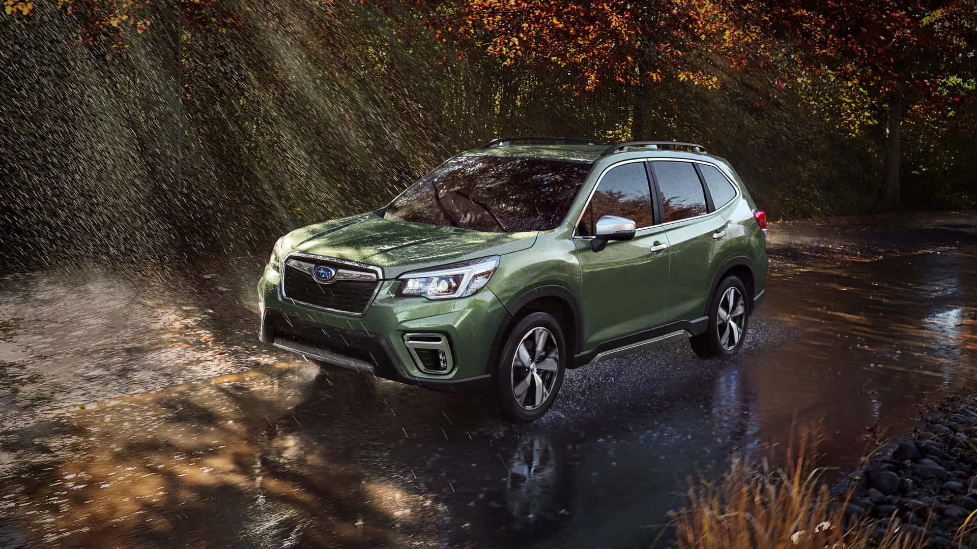 Caption: Swerving Subaru Forester Amid Lush Greenery Wallpaper