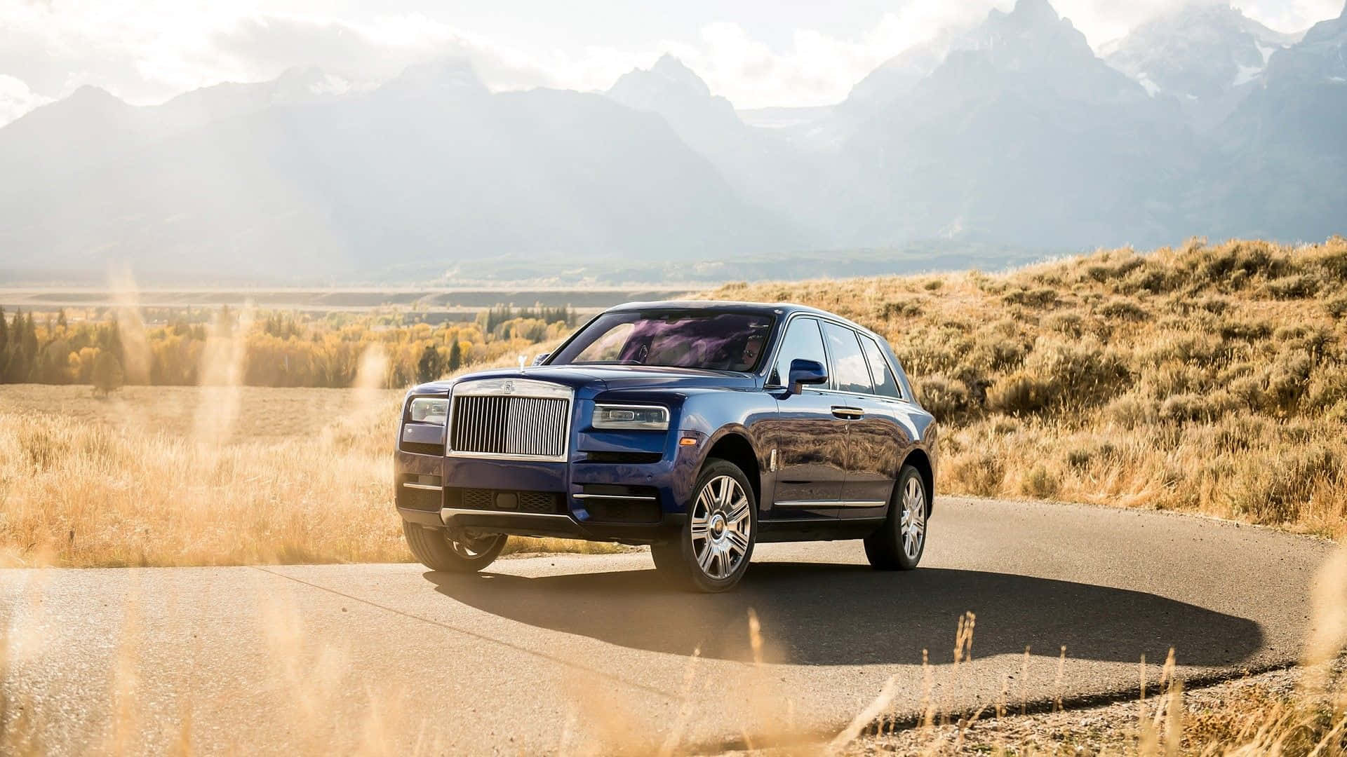 Caption: The Epitome Of Luxury: Rolls-royce Cullinan In Stunning Silver Wallpaper