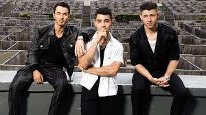 Caption: The Iconic Jonas Brothers At Music Event Wallpaper