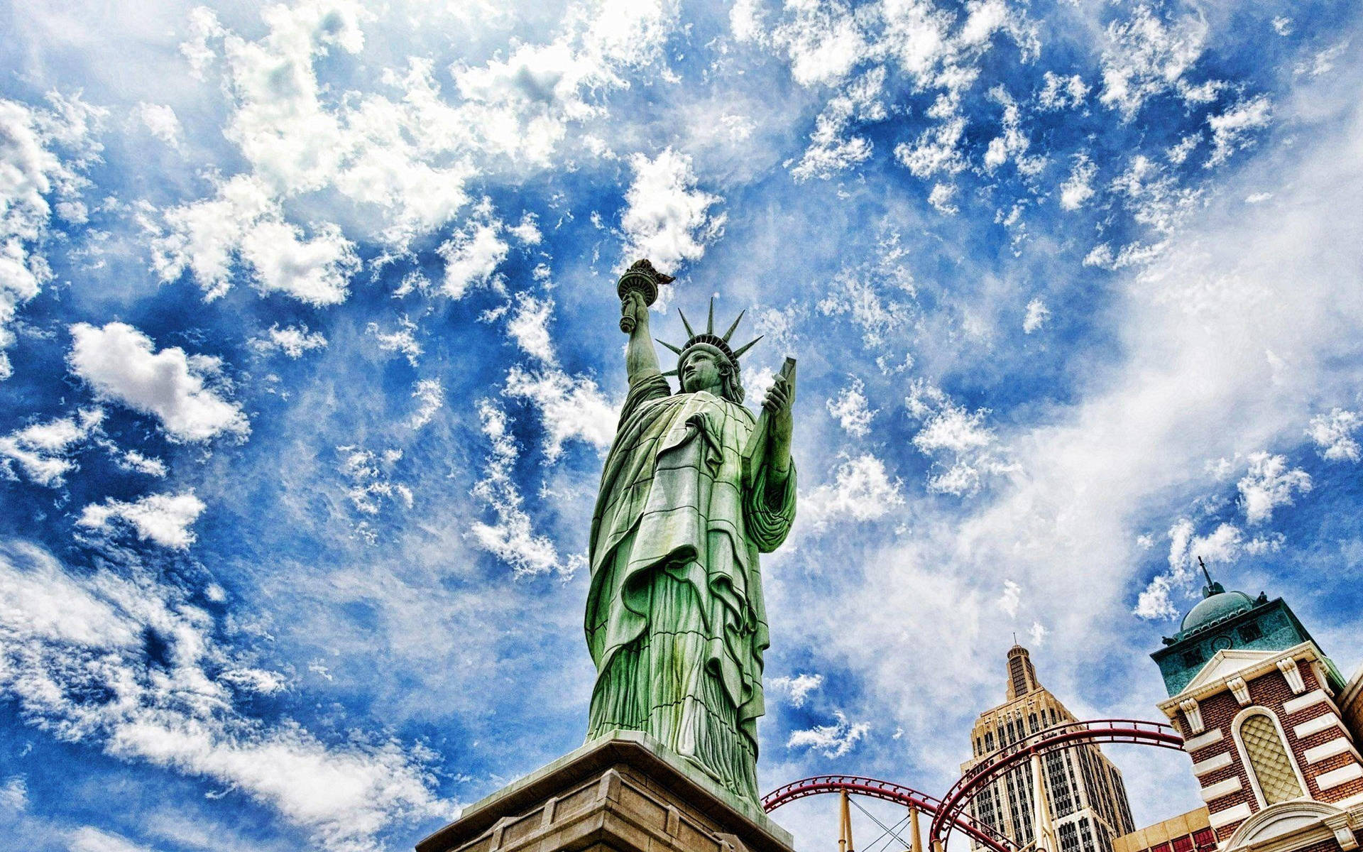 Caption: The Majestic Statue Of Liberty Illuminated At Twilight Wallpaper
